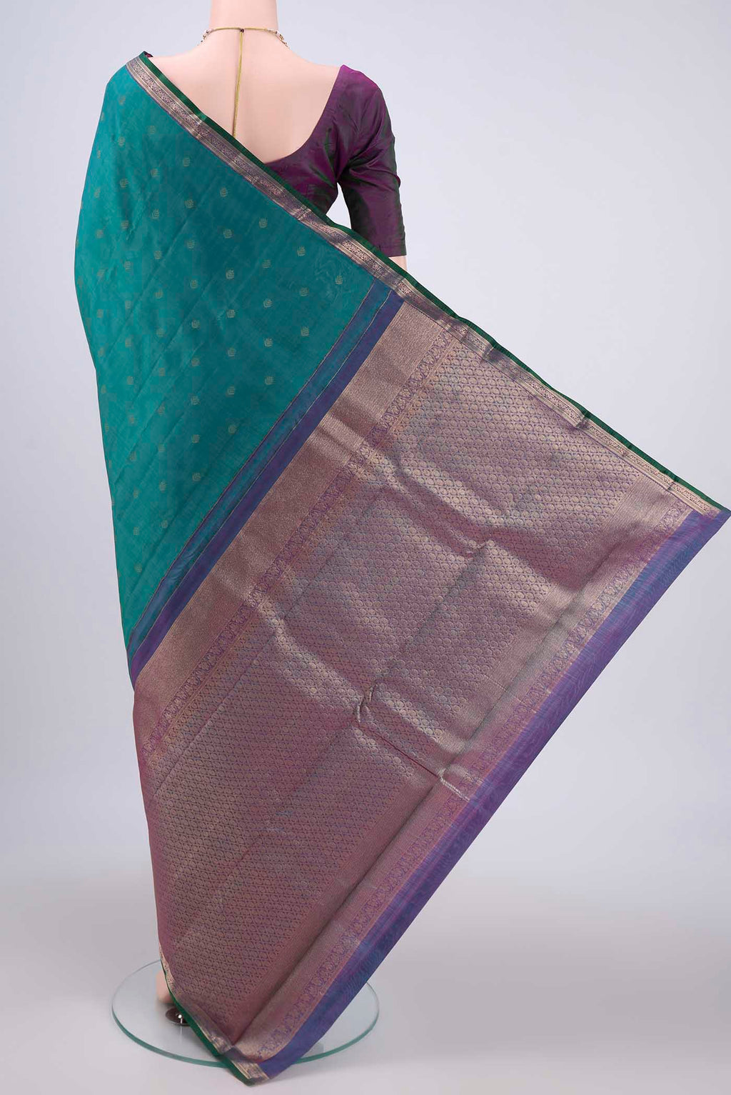 Flat view of Green Kanchipuram Silk Saree with Zari Butta on the body and Zari Border. 