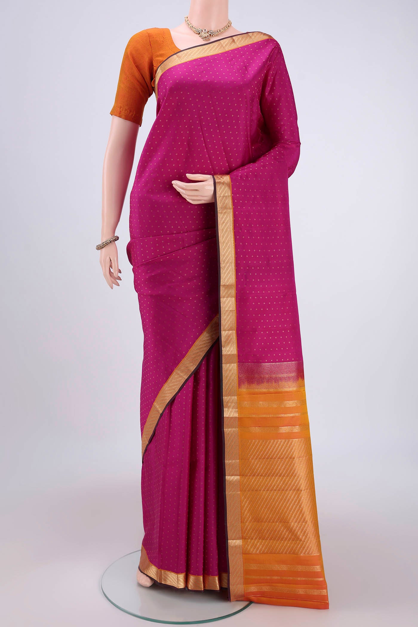 Pink Kanchipuram Silk Saree with Zari Butta on the body and Zari Border.  displayed on a mannequin