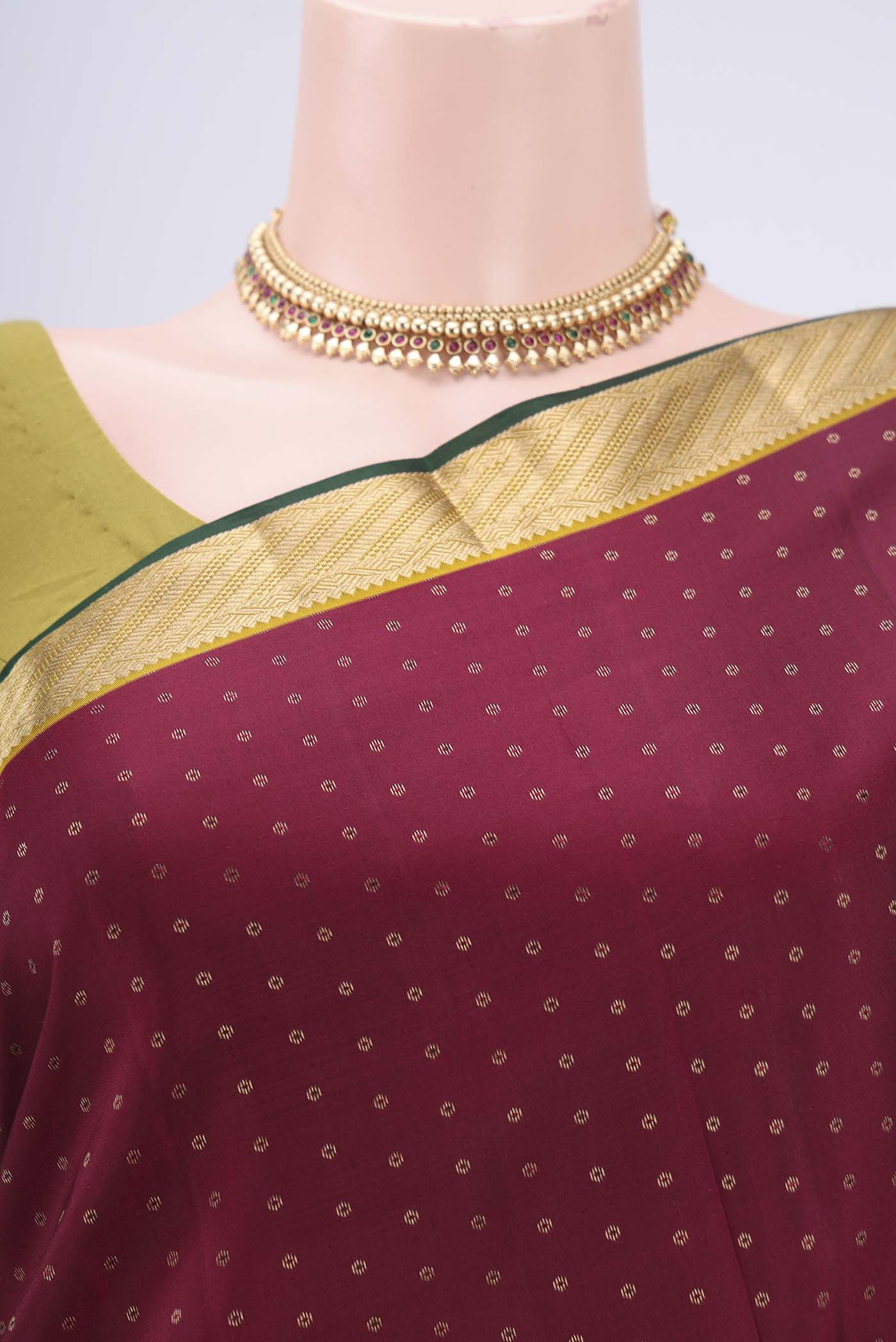 Border image of Maroon Kanchipuram Silk Saree with Zari Butta on the body and Zari Border. 