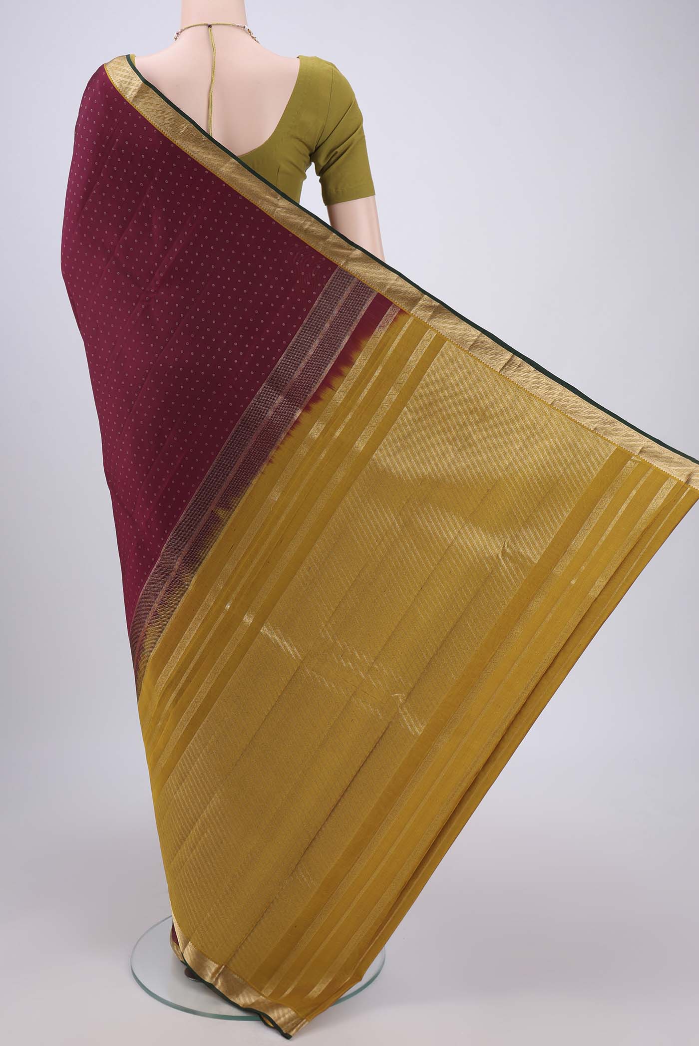 Flat view of Maroon Kanchipuram Silk Saree with Zari Butta on the body and Zari Border. 
