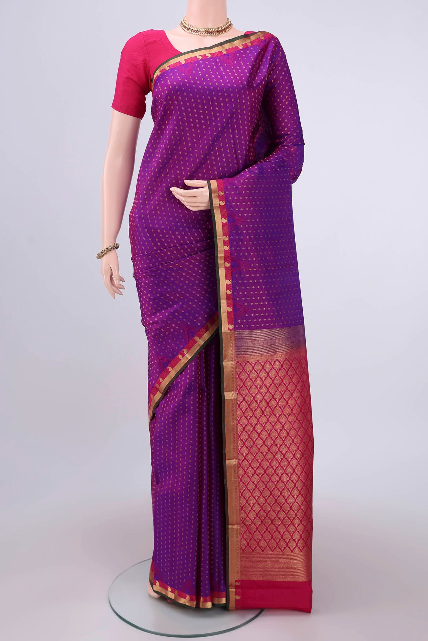 Magenta Kanchipuram Silk Saree with Zari Butta on the body and Zari Border.  displayed on a mannequin