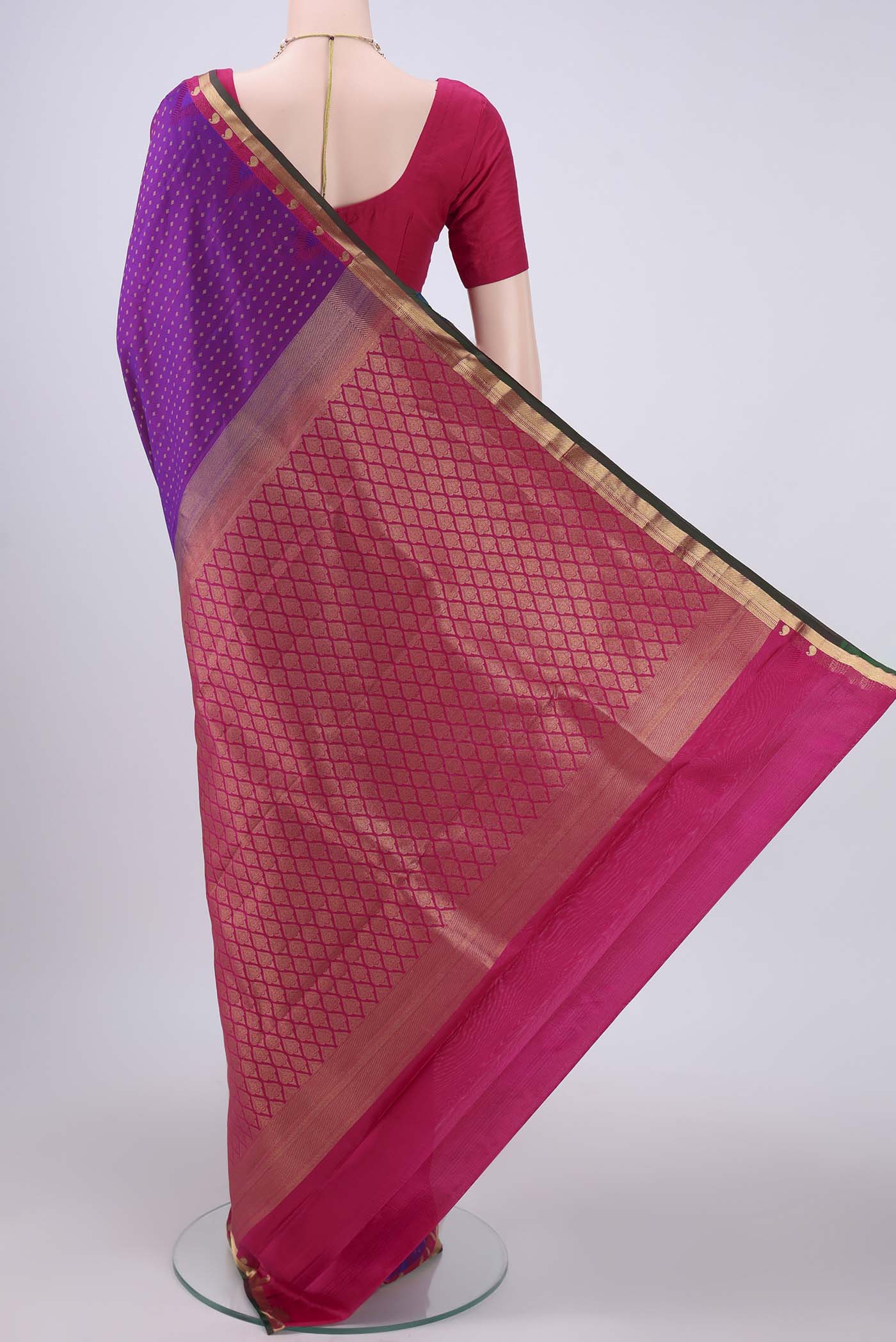 Flat view of Magenta Kanchipuram Silk Saree with Zari Butta on the body and Zari Border. 