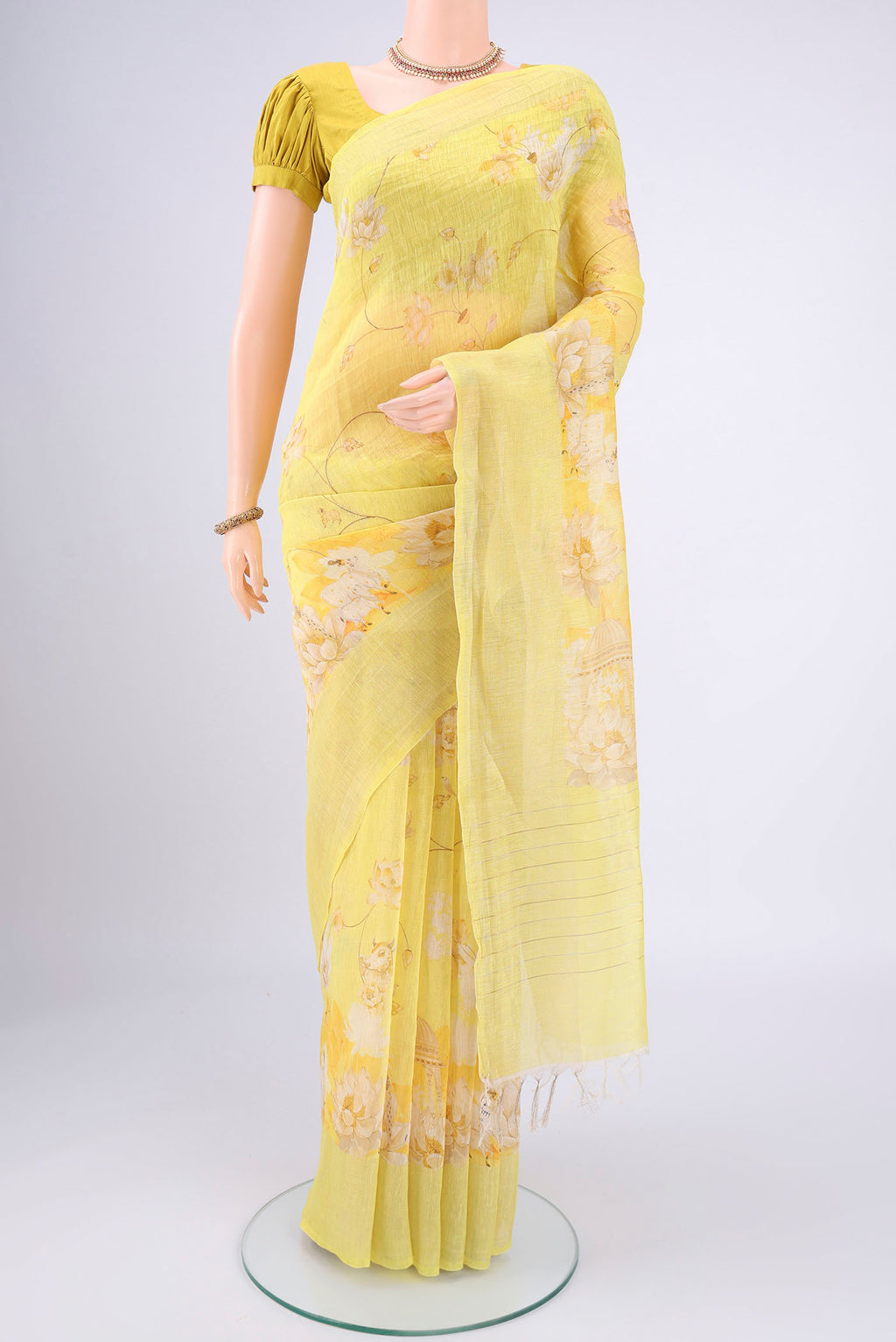 Lemon Yellow Linen Saree with Animal Print on the body and Zari Border.  displayed on a mannequin