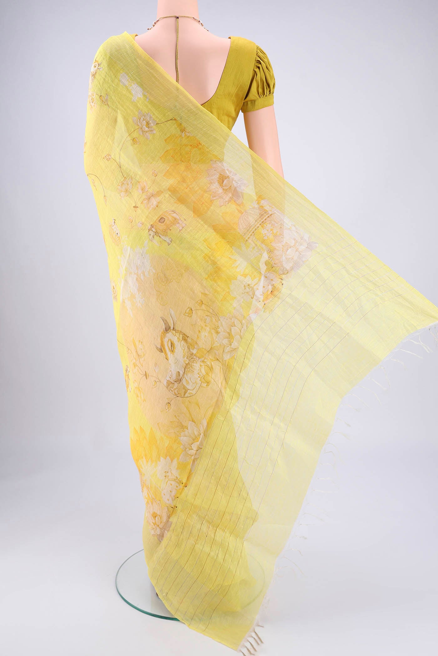 Flat view of Lemon Yellow Linen Saree with Animal Print on the body and Zari Border. 