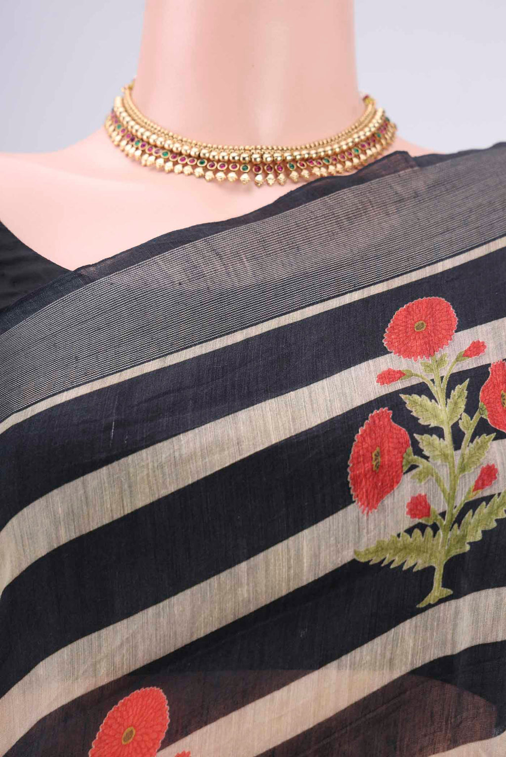 Border image of Black Linen Saree with Floral Print on the body and Zari Border. 