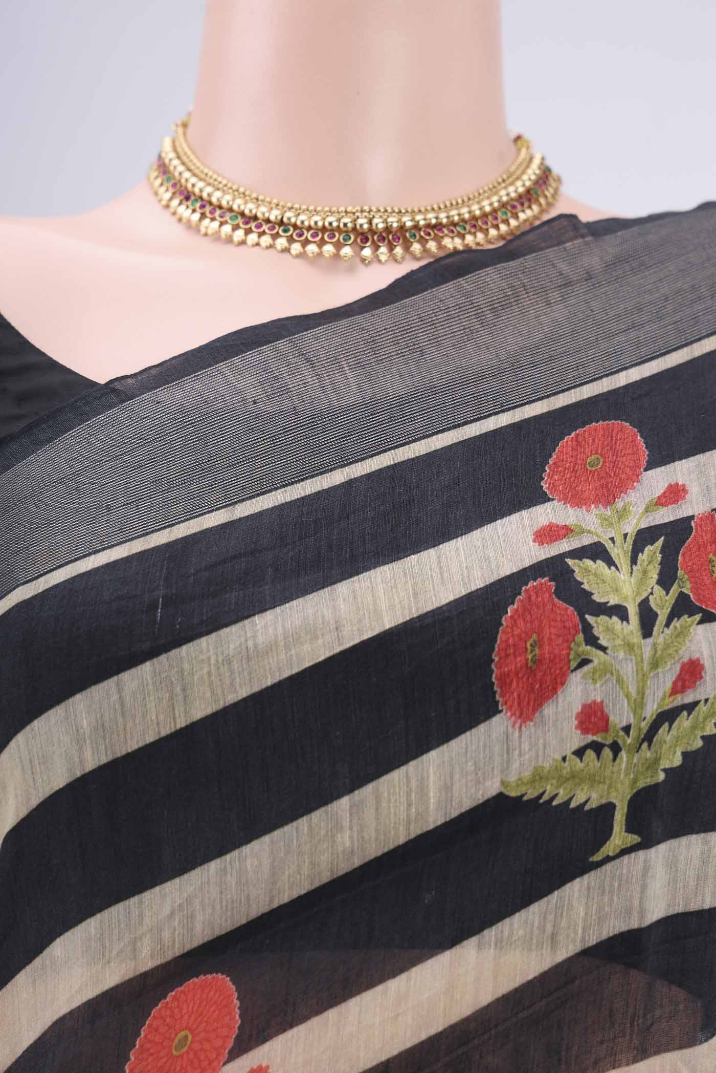 Border image of Black Linen Saree with Floral Print on the body and Zari Border. 