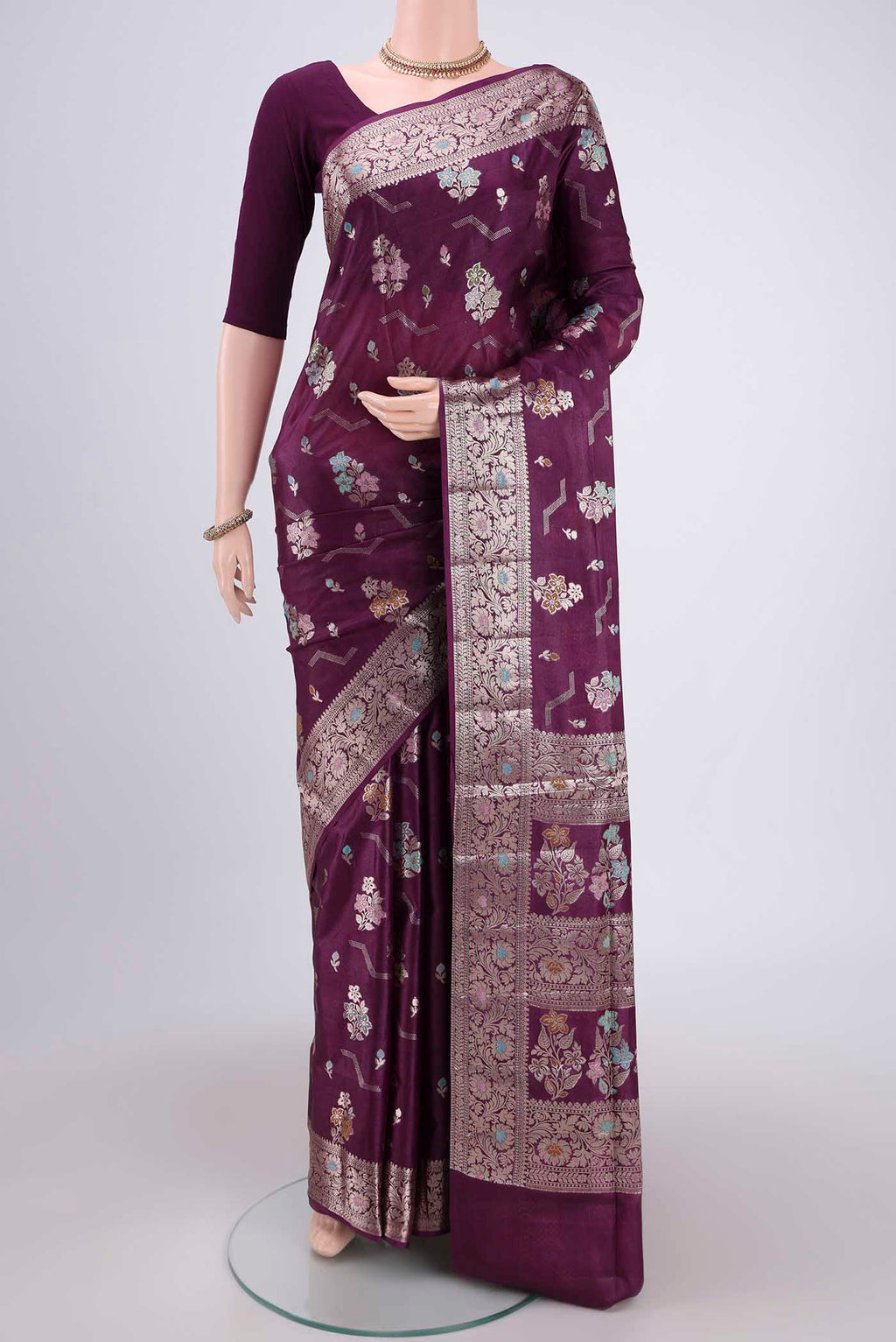 Burgundy Banarasi Raw Silk Saree with Zari And Thread Butta on the body and Zari And Thread Border.  displayed on a mannequin