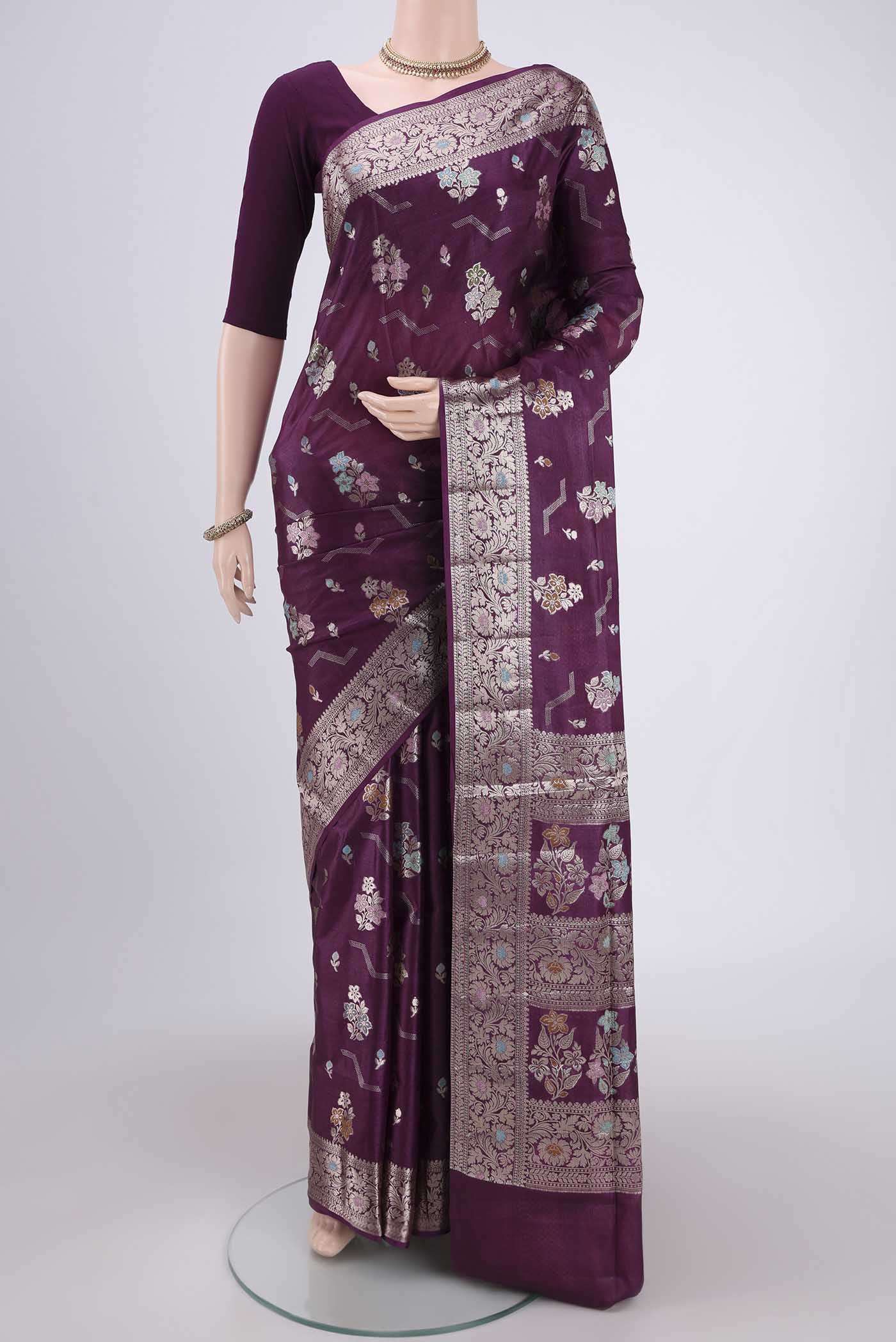 Burgundy Banarasi Raw Silk Saree with Zari And Thread Butta on the body and Zari And Thread Border.  displayed on a mannequin