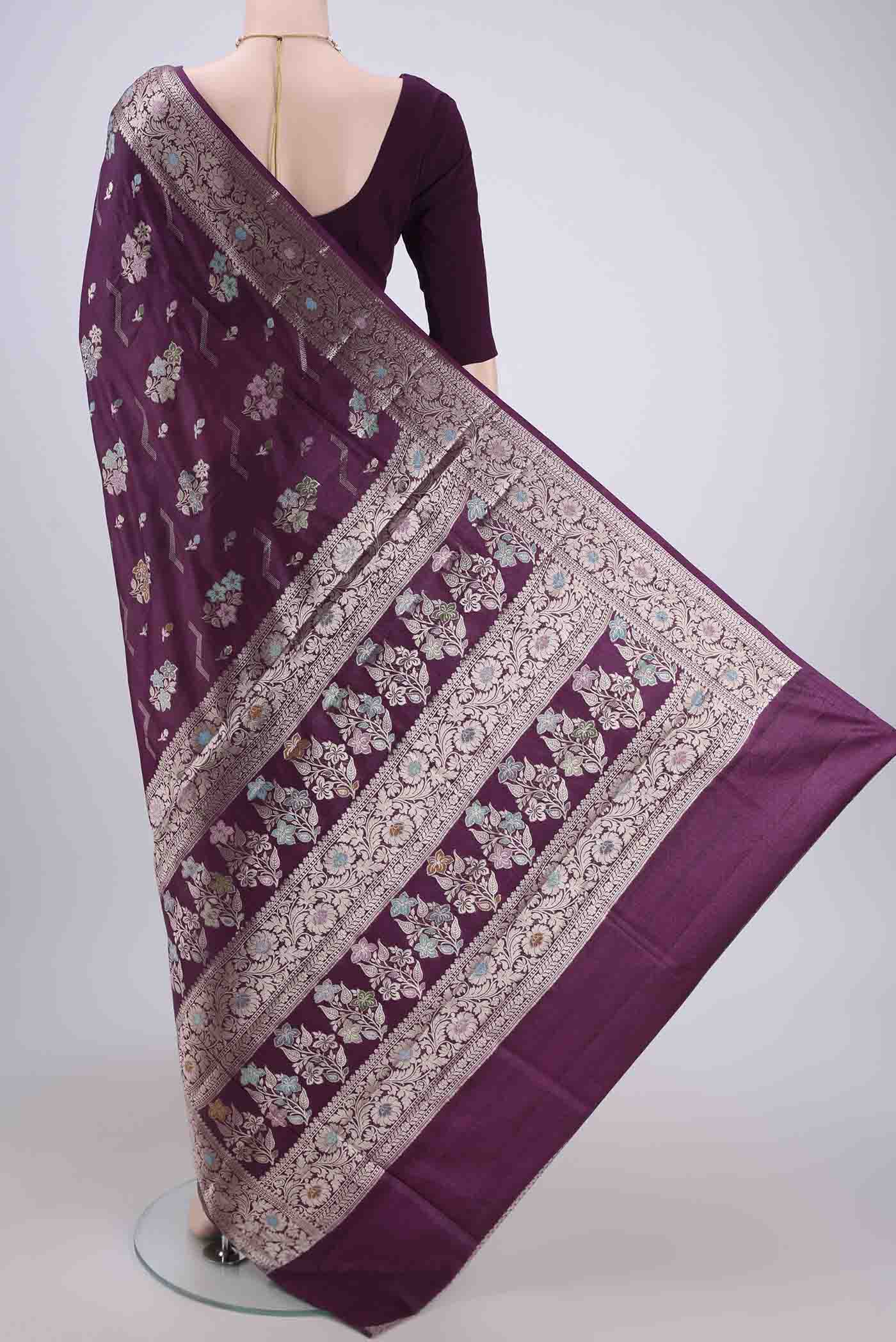 Flat view of Burgundy Banarasi Raw Silk Saree with Zari And Thread Butta on the body and Zari And Thread Border. 