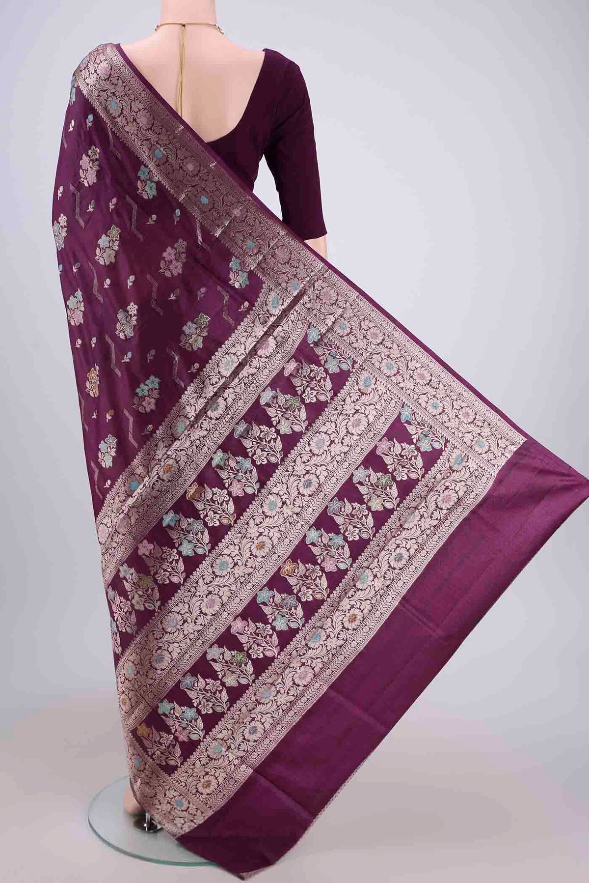 Flat view of Burgundy Banarasi Raw Silk Saree with Zari And Thread Butta on the body and Zari And Thread Border. 