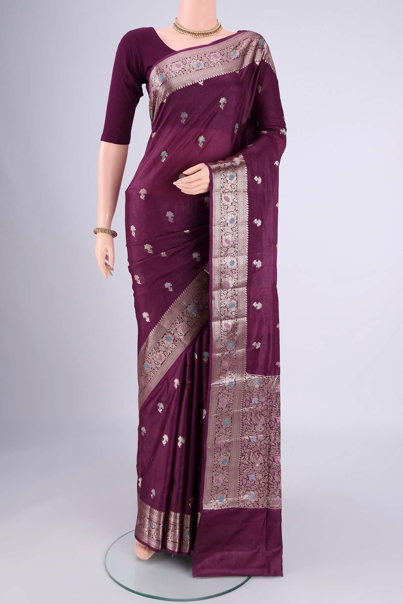 Magenta Banarasi Tussar Silk Saree with Zari And Thread Butta on the body and Zari And Thread Border.  displayed on a mannequin