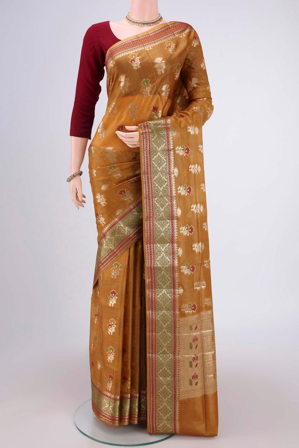 Mustard Banarasi Tussar Silk Saree with Zari Butta on the body and Zari And Thread Border.  displayed on a mannequin