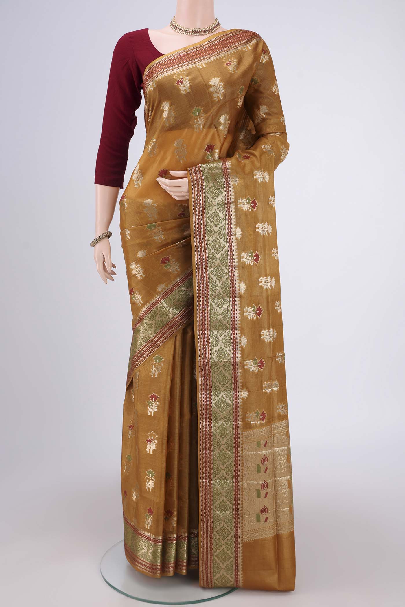Mustard Banarasi Tussar Silk Saree with Zari Butta on the body and Zari And Thread Border.  displayed on a mannequin