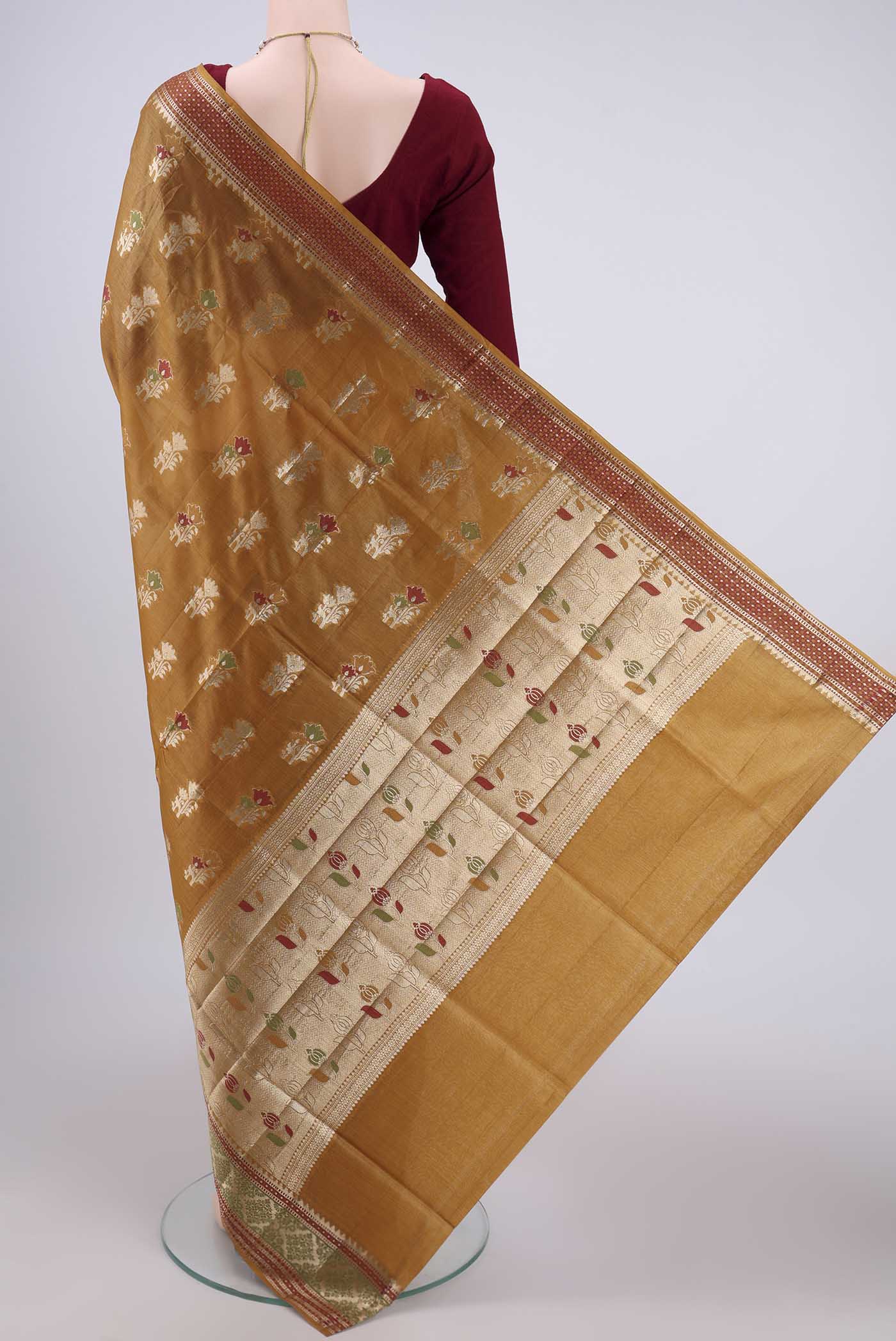 Flat view of Mustard Banarasi Tussar Silk Saree with Zari Butta on the body and Zari And Thread Border. 