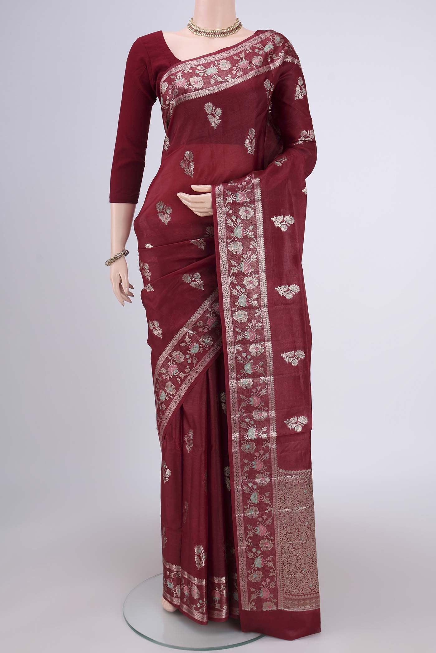Maroon Banarasi Tussar Silk Saree with Zari Butta on the body and Zari And Thread Border.  displayed on a mannequin