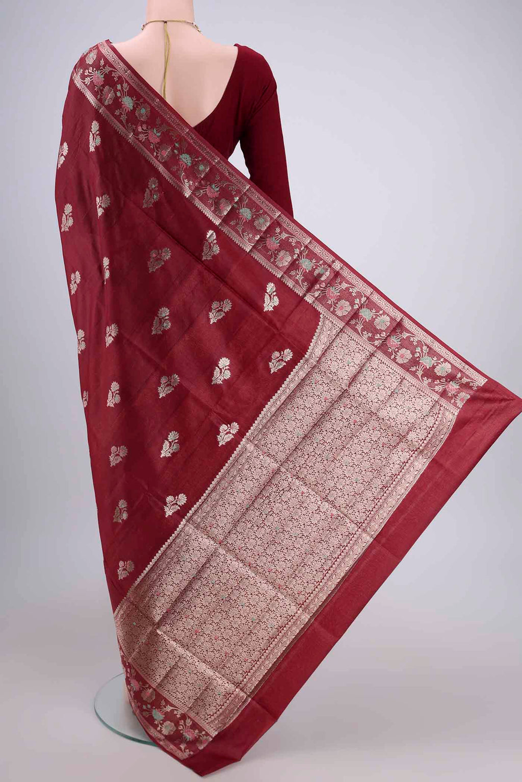 Flat view of Maroon Banarasi Tussar Silk Saree with Zari Butta on the body and Zari And Thread Border. 