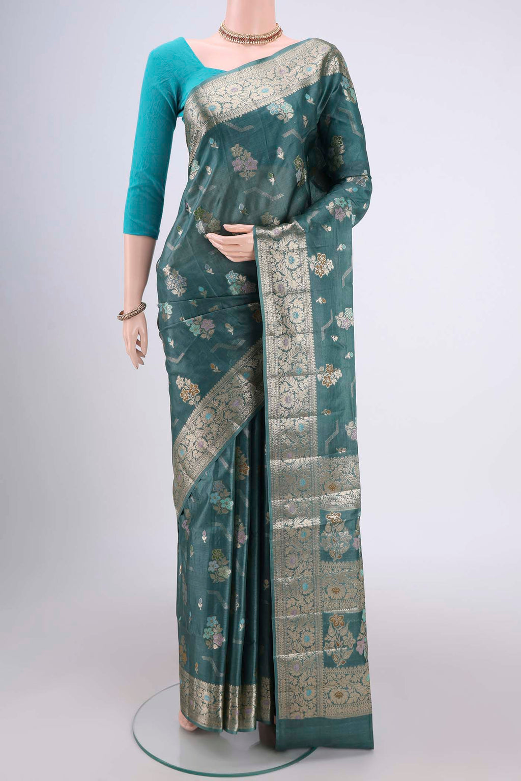 Maya Blue Banarasi Tussar Silk Saree with Zari And Thread Butta on the body and Zari And Thread Border.  displayed on a mannequin
