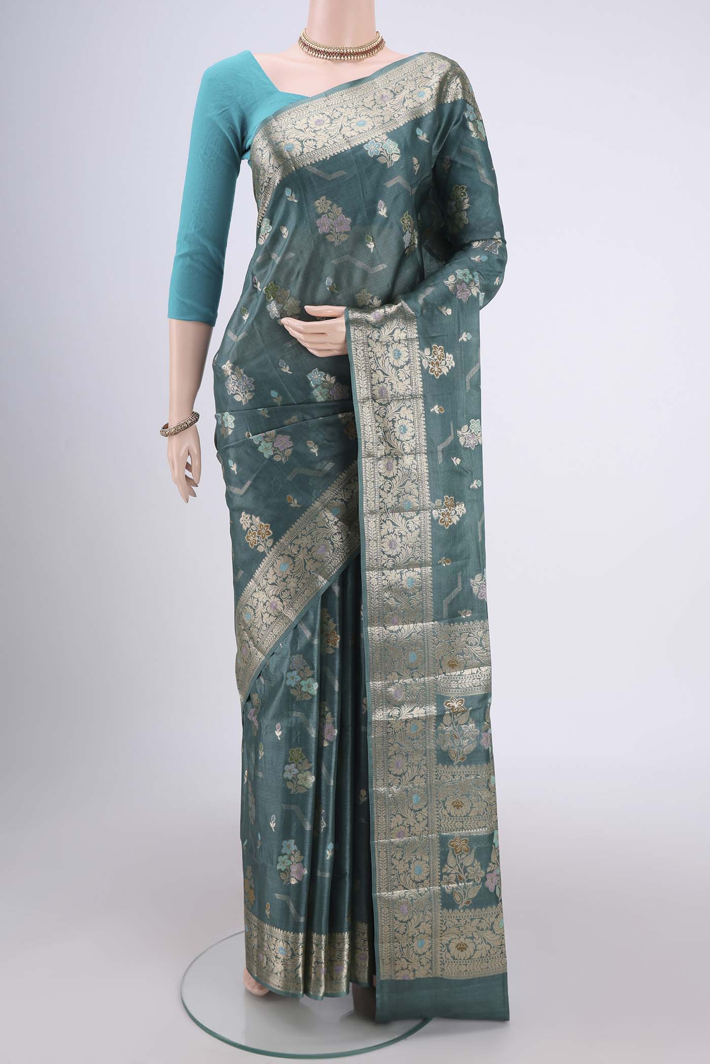 Maya Blue Banarasi Tussar Silk Saree with Zari And Thread Butta on the body and Zari And Thread Border.  displayed on a mannequin
