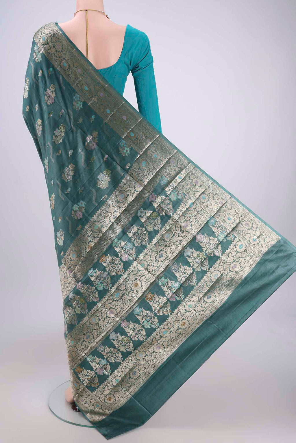 Flat view of Maya Blue Banarasi Tussar Silk Saree with Zari And Thread Butta on the body and Zari And Thread Border. 