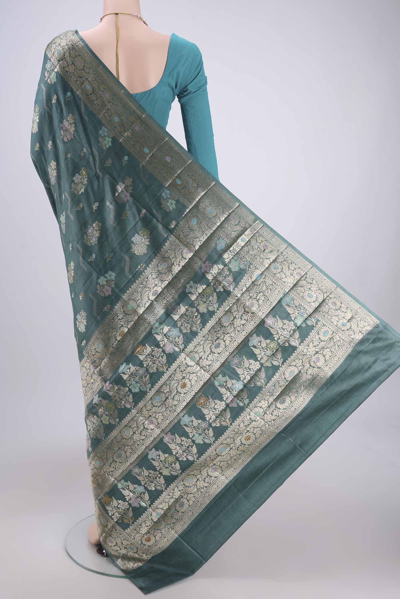 Flat view of Maya Blue Banarasi Tussar Silk Saree with Zari And Thread Butta on the body and Zari And Thread Border. 