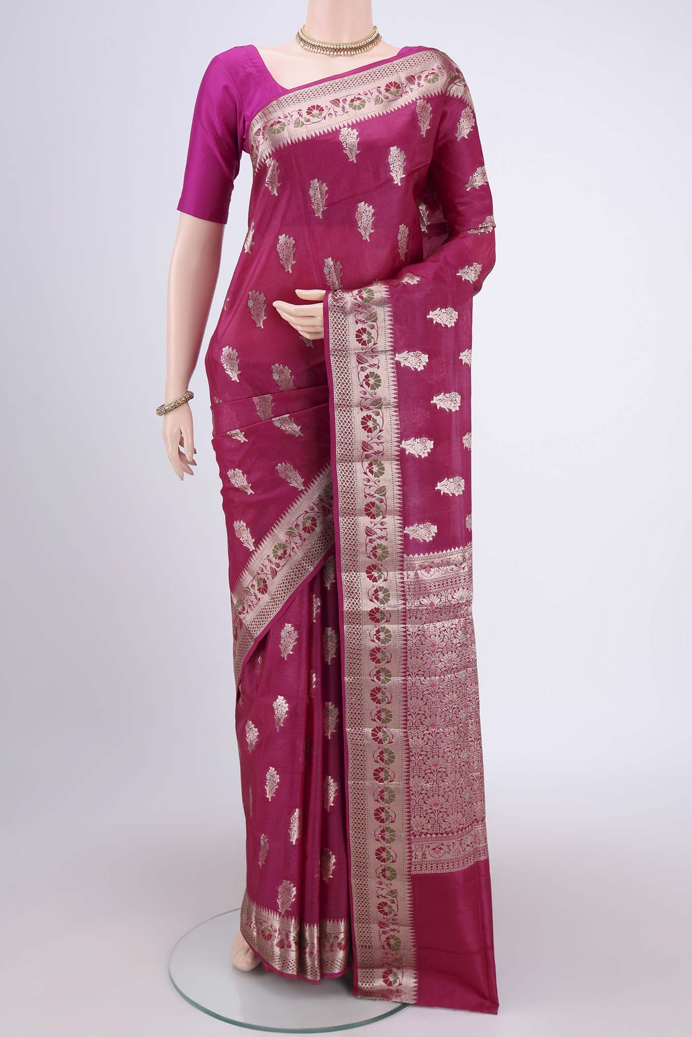 Rani Pink Banarasi Raw Silk Saree with Zari And Thread Butta on the body and Zari And Thread Border.  displayed on a mannequin