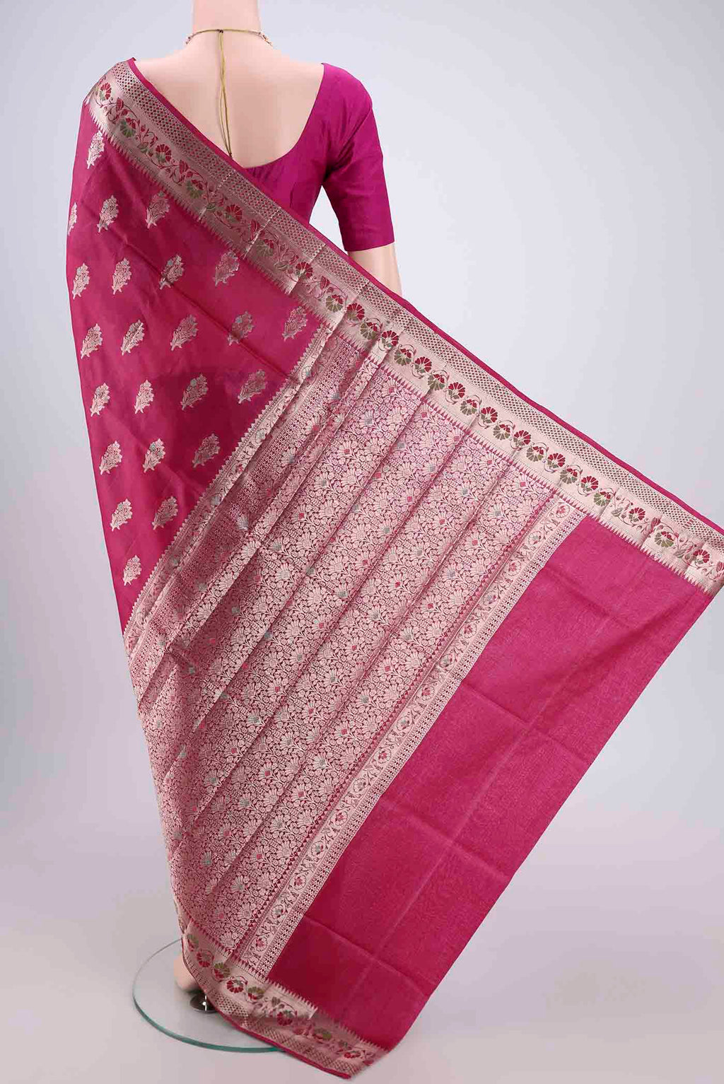 Flat view of Rani Pink Banarasi Raw Silk Saree with Zari And Thread Butta on the body and Zari And Thread Border. 