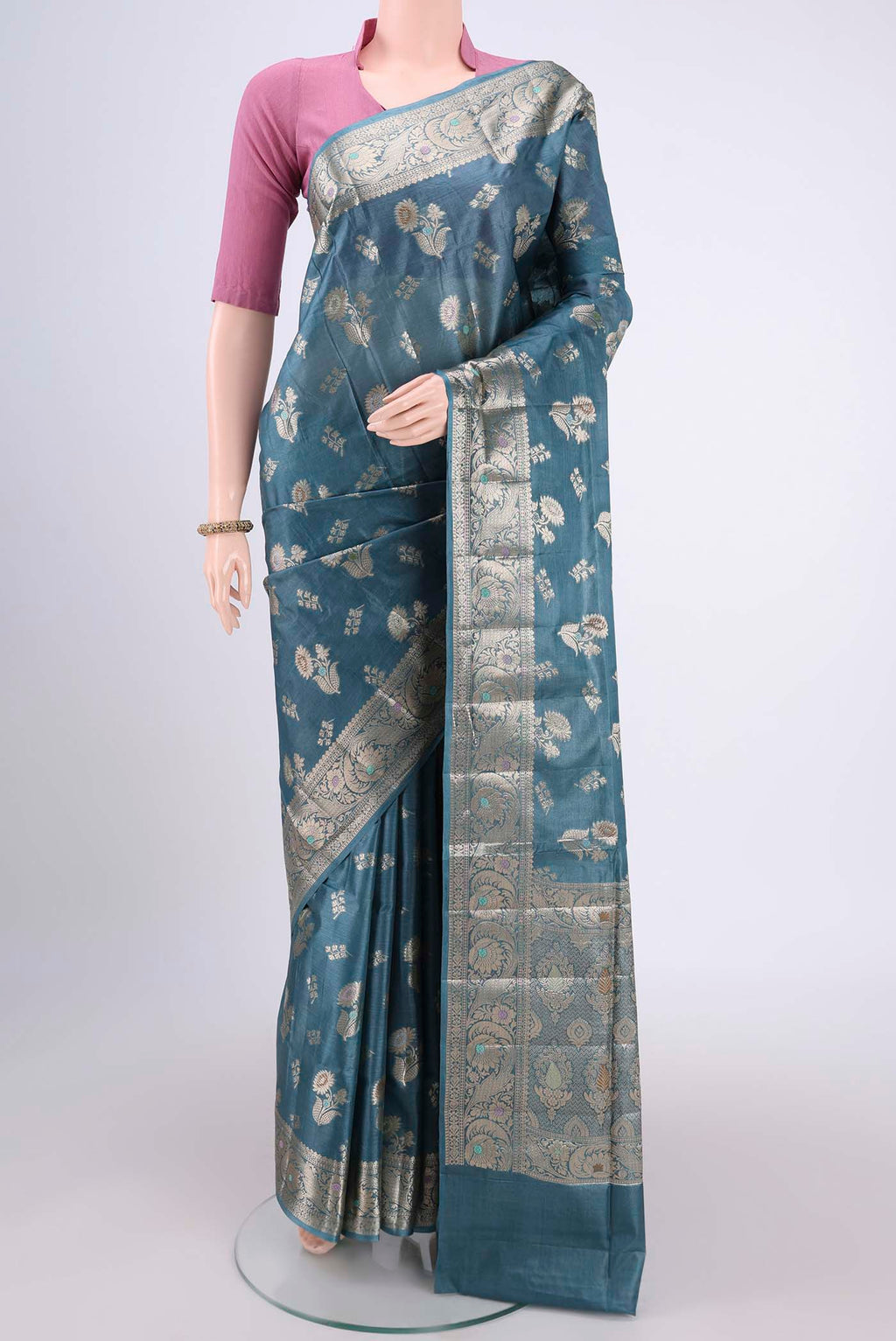 Maya Blue Banarasi Tussar Silk Saree with Zari And Thread Butta on the body and Zari And Thread Border.  displayed on a mannequin