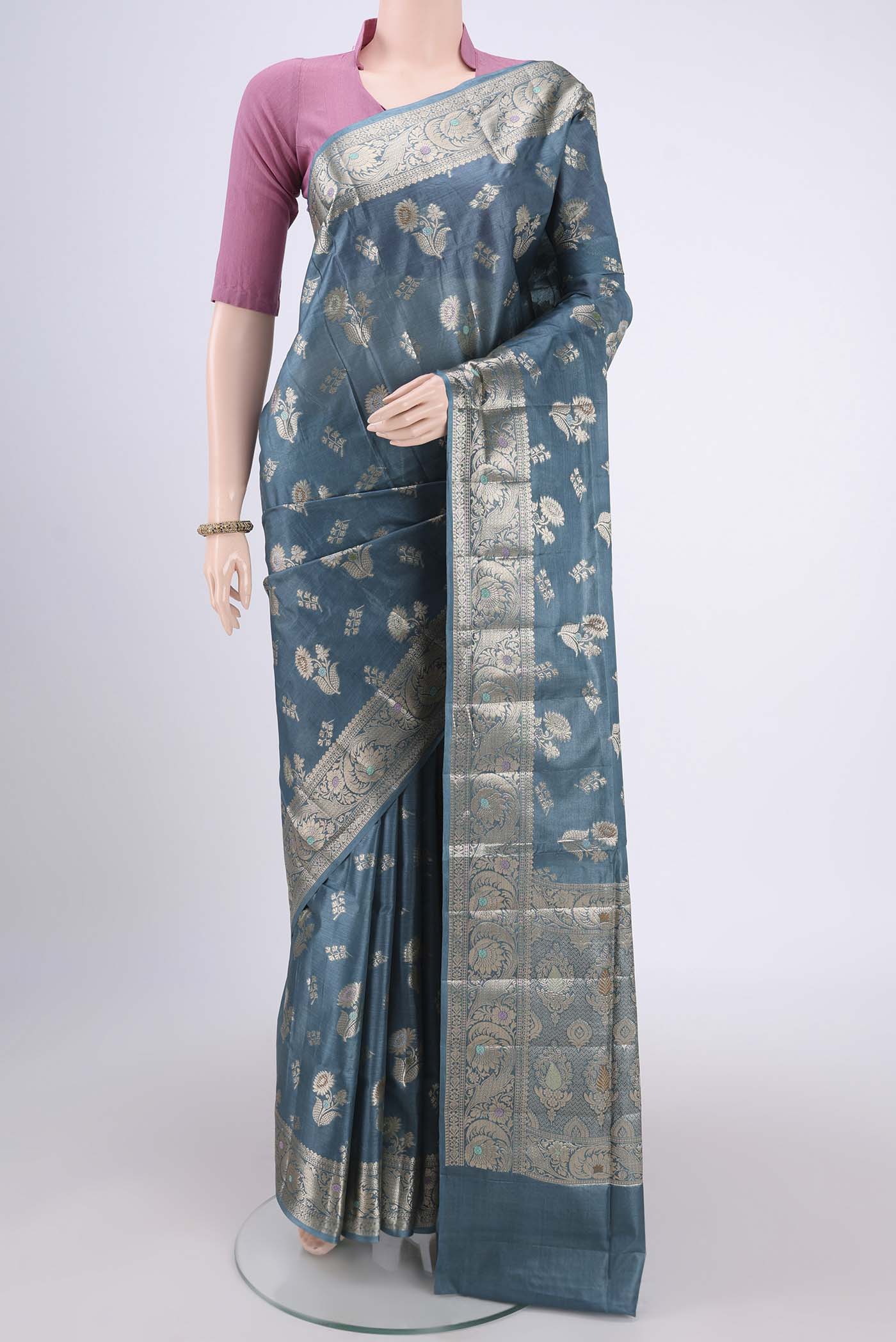 Maya Blue Banarasi Tussar Silk Saree with Zari And Thread Butta on the body and Zari And Thread Border.  displayed on a mannequin