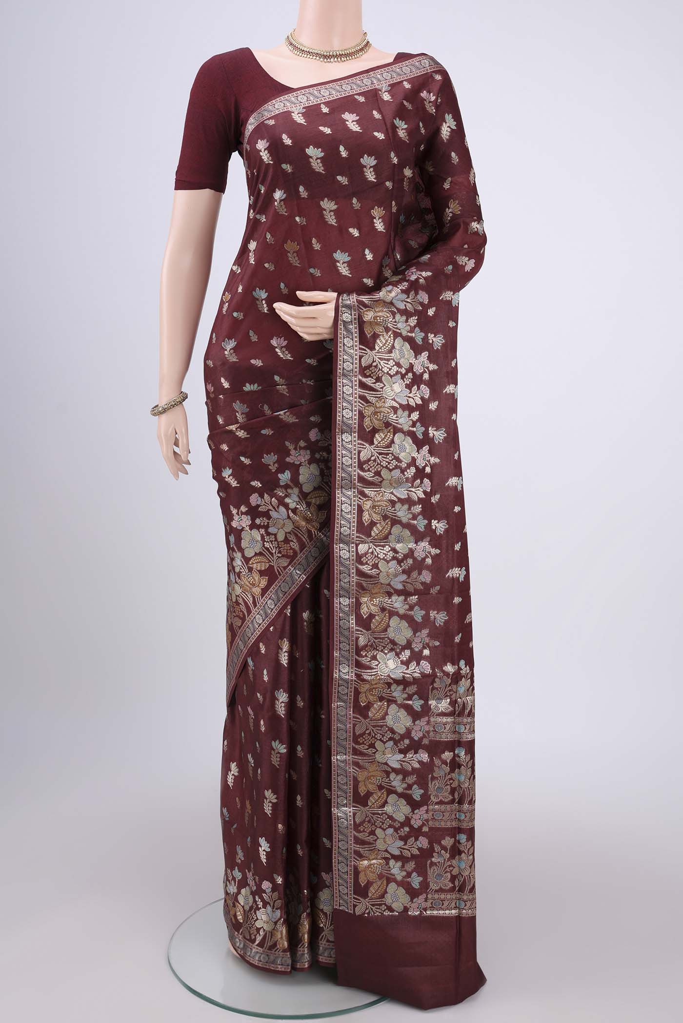 Brown Banarasi Raw Silk Saree with Zari And Thread Butta on the body and Zari And Thread Border.  displayed on a mannequin