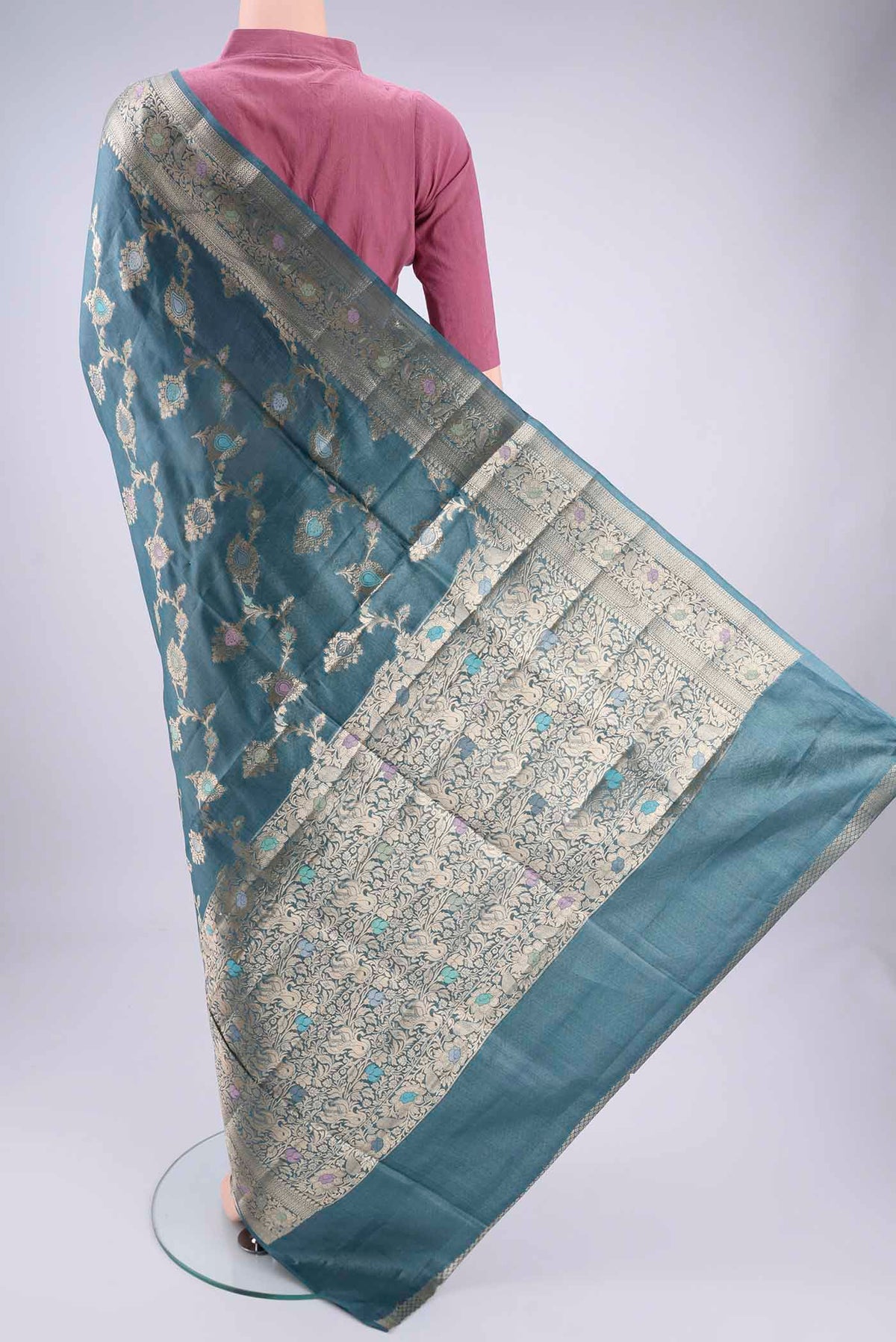 Flat view of Maya Blue Banarasi Tussar Silk Saree with Zari Brocade on the body and Zari And Thread Border. 
