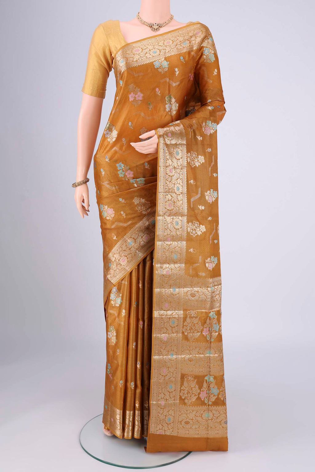 Mustard Banarasi Tussar Silk Saree with Zari And Thread Butta on the body and Zari And Thread Border.  displayed on a mannequin