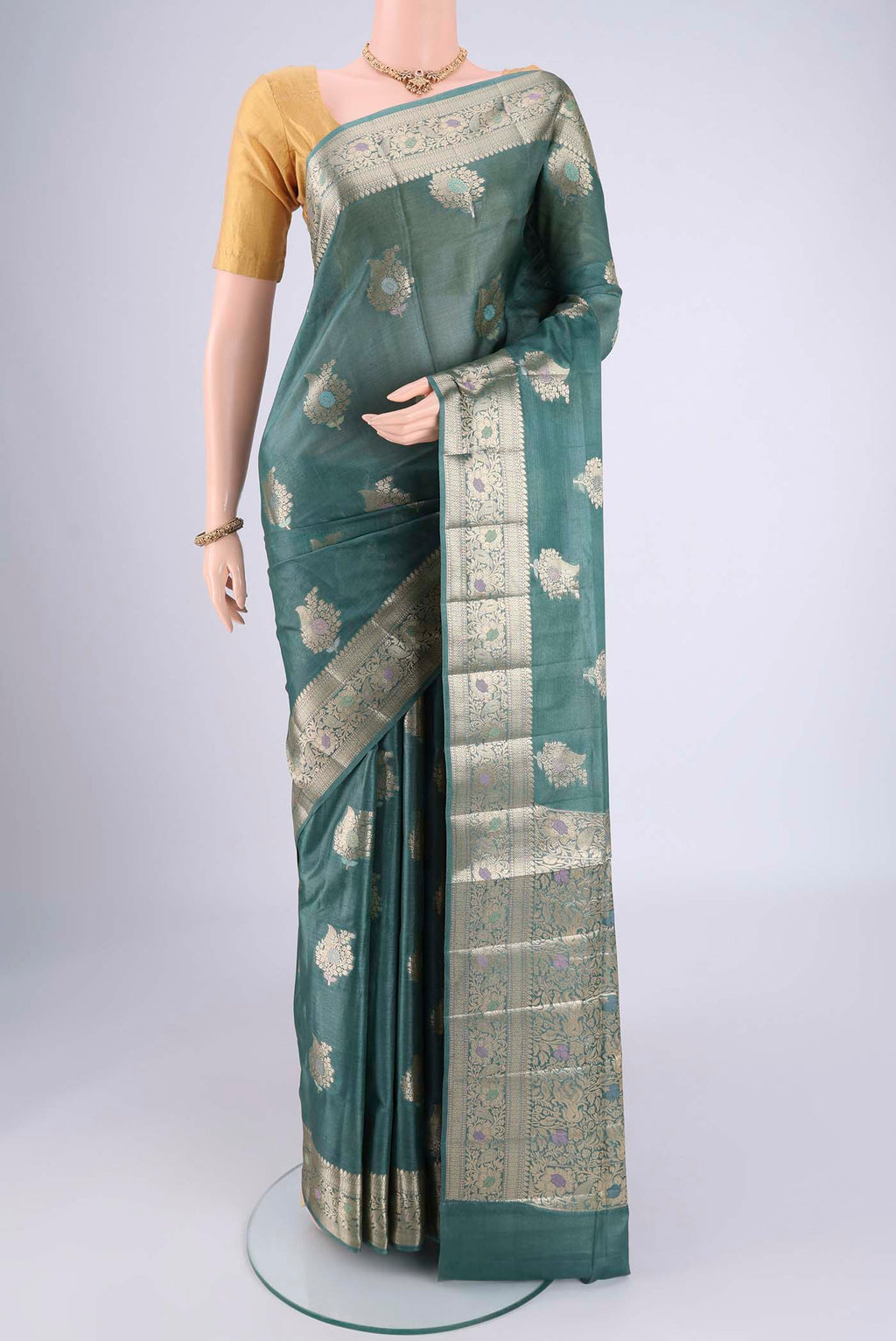 Maya Blue Banarasi Tussar Silk Saree with Zari And Thread Butta on the body and Zari And Thread Border.  displayed on a mannequin