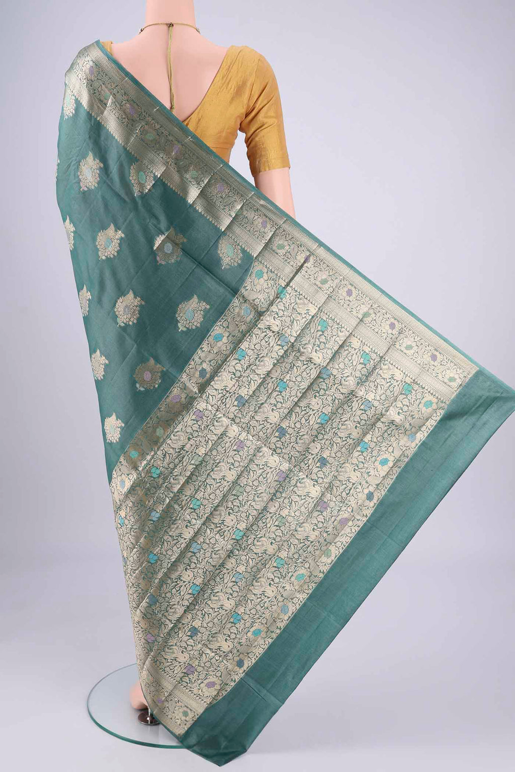Flat view of Maya Blue Banarasi Tussar Silk Saree with Zari And Thread Butta on the body and Zari And Thread Border. 
