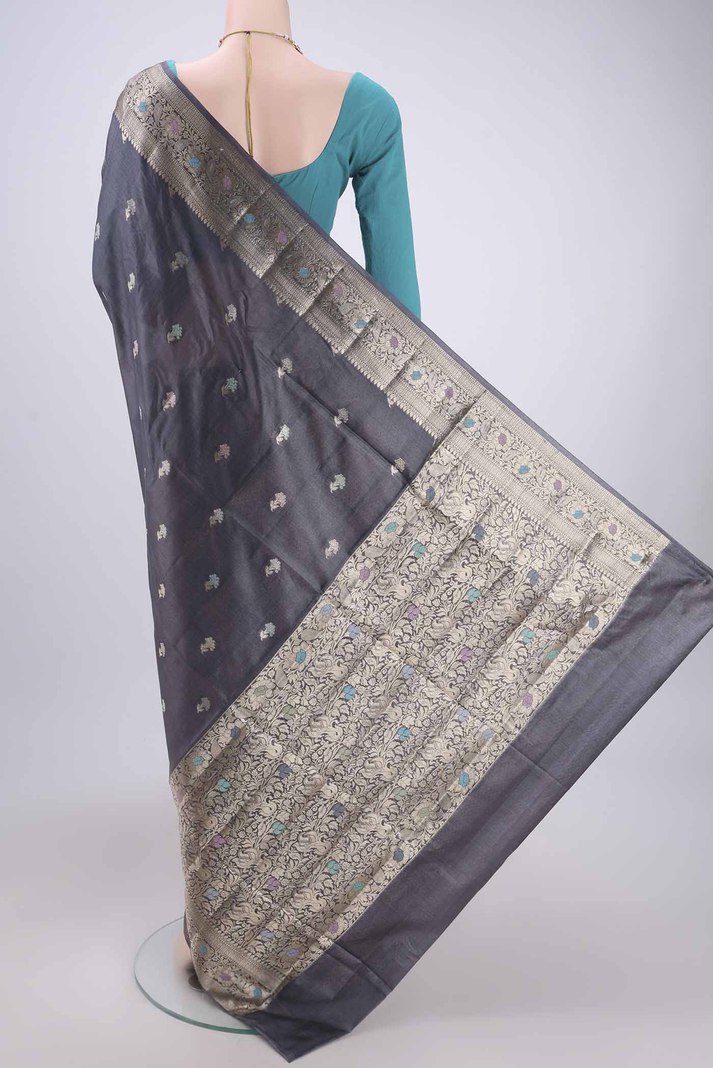 Flat view of Davys Grey Banarasi Tussar Silk Saree with Zari And Thread Butta on the body and Zari And Thread Border. 