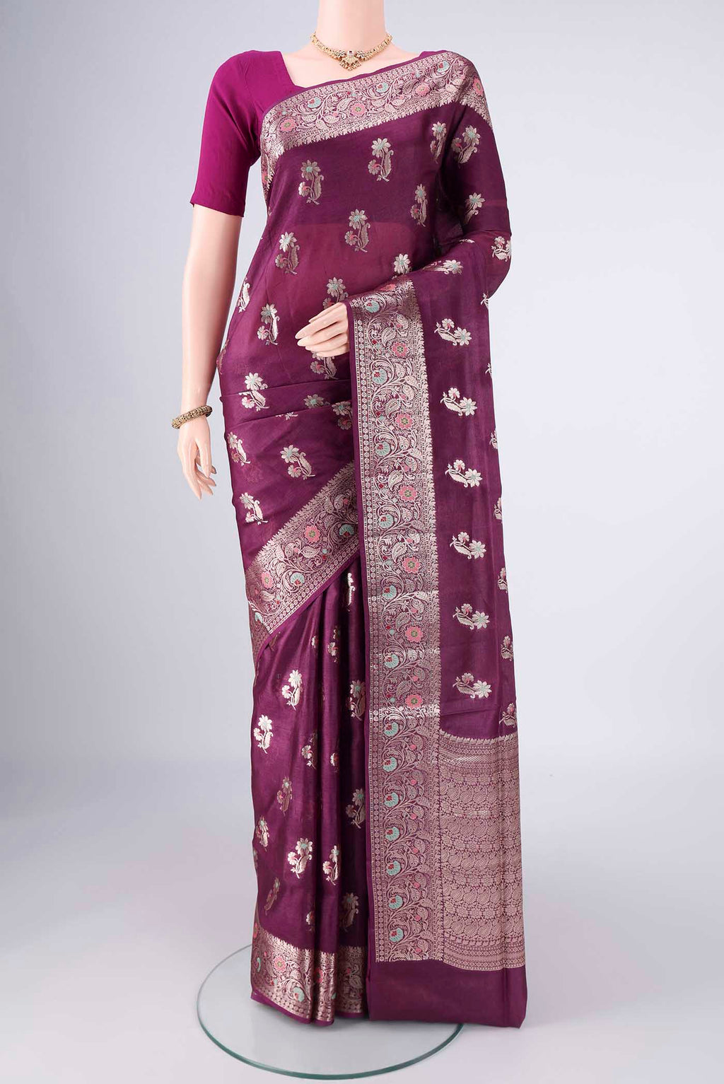 Burgundy Banarasi Tussar Silk Saree with Zari And Thread Butta on the body and Zari Border.  displayed on a mannequin