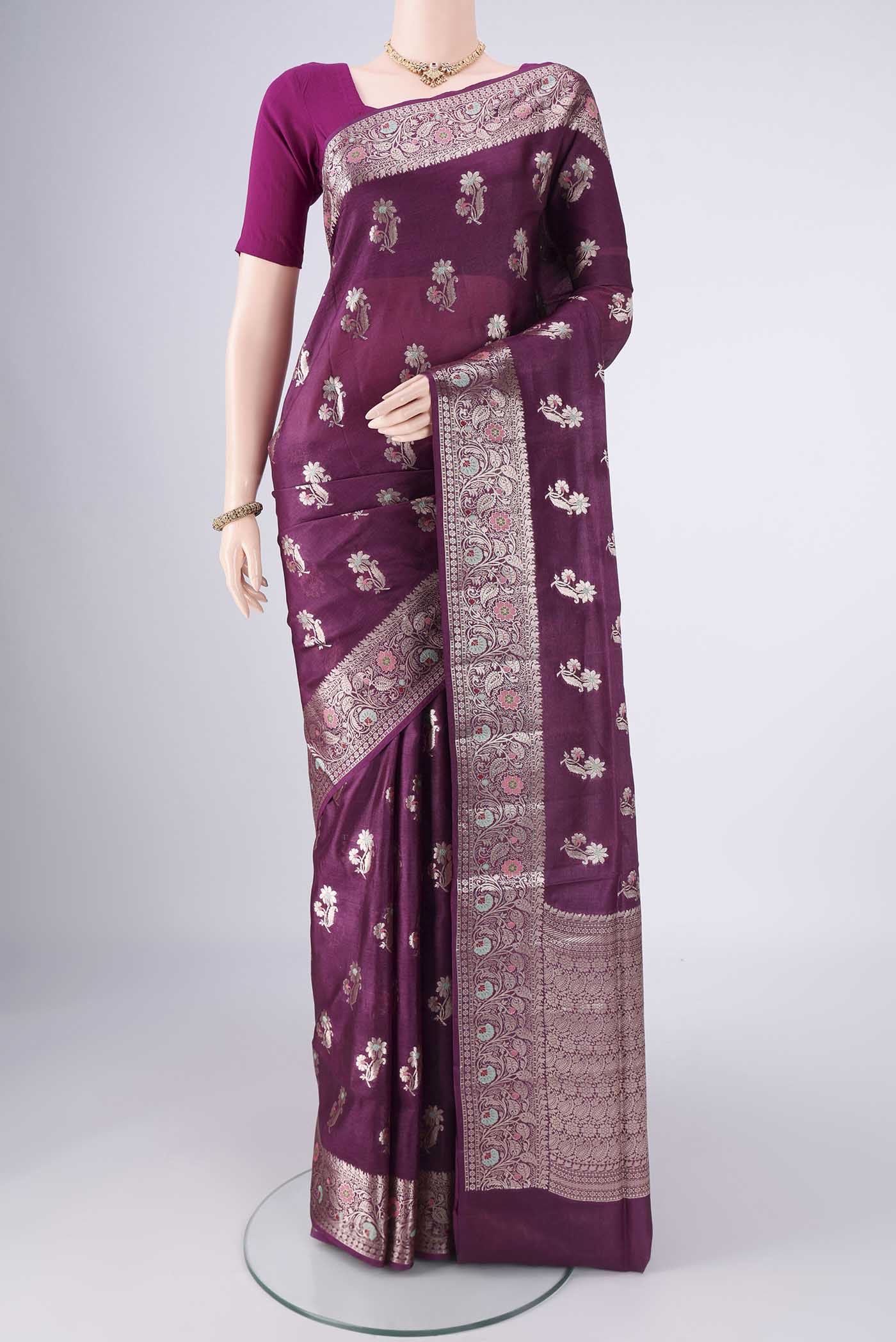 Burgundy Banarasi Tussar Silk Saree with Zari And Thread Butta on the body and Zari Border.  displayed on a mannequin