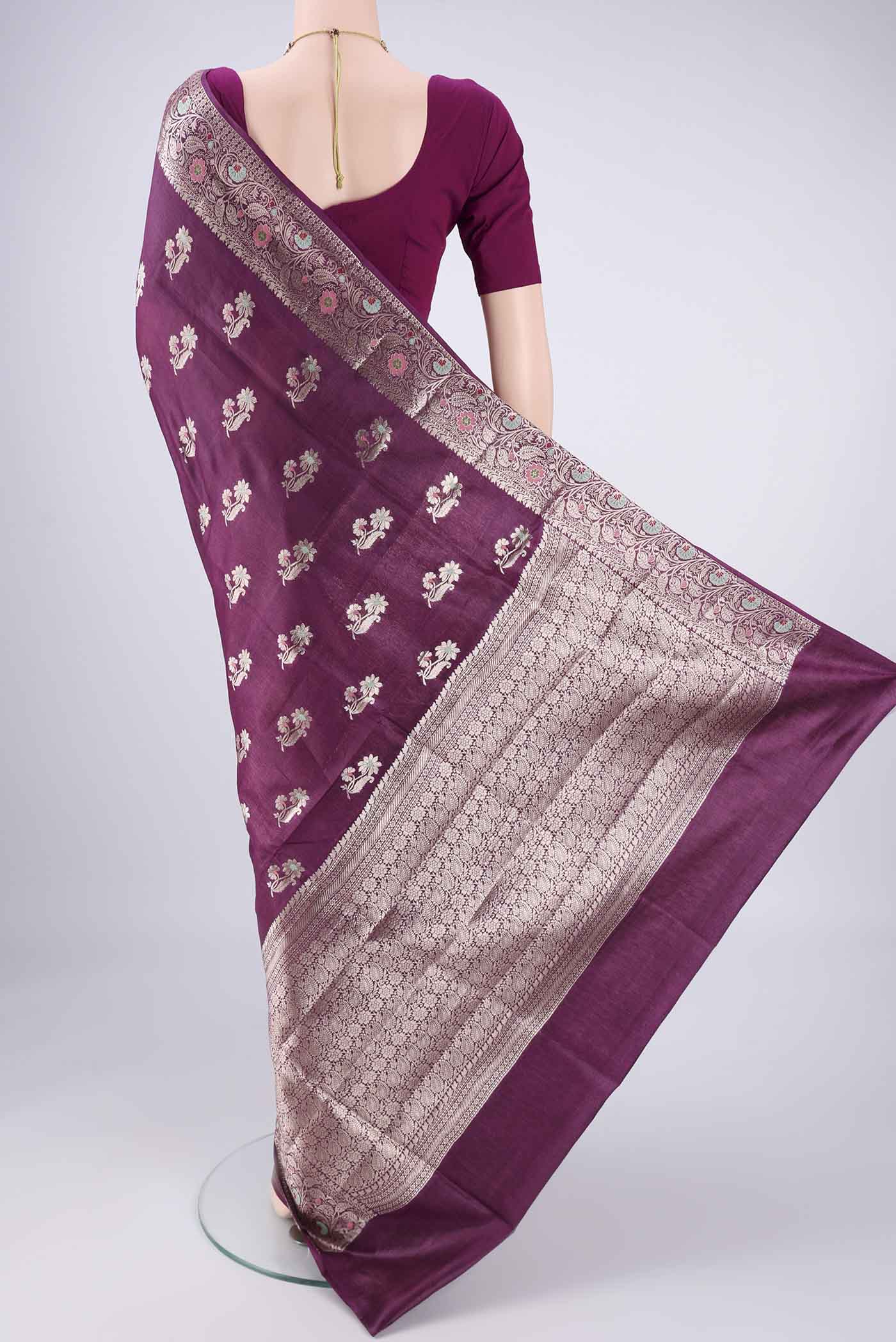 Flat view of Burgundy Banarasi Tussar Silk Saree with Zari And Thread Butta on the body and Zari Border. 