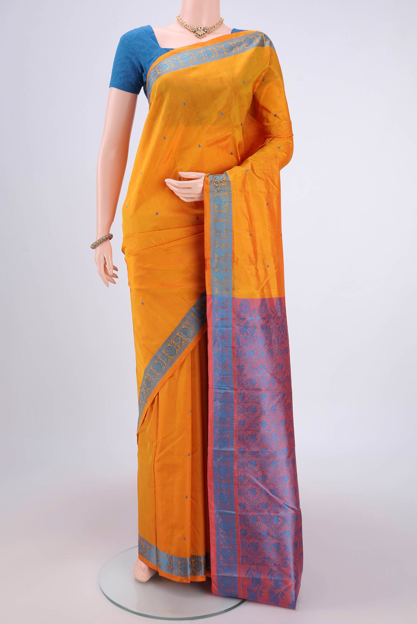 Yellow Kanchipuram Silk Saree with Thread Butta on the body and Thread Border.  displayed on a mannequin