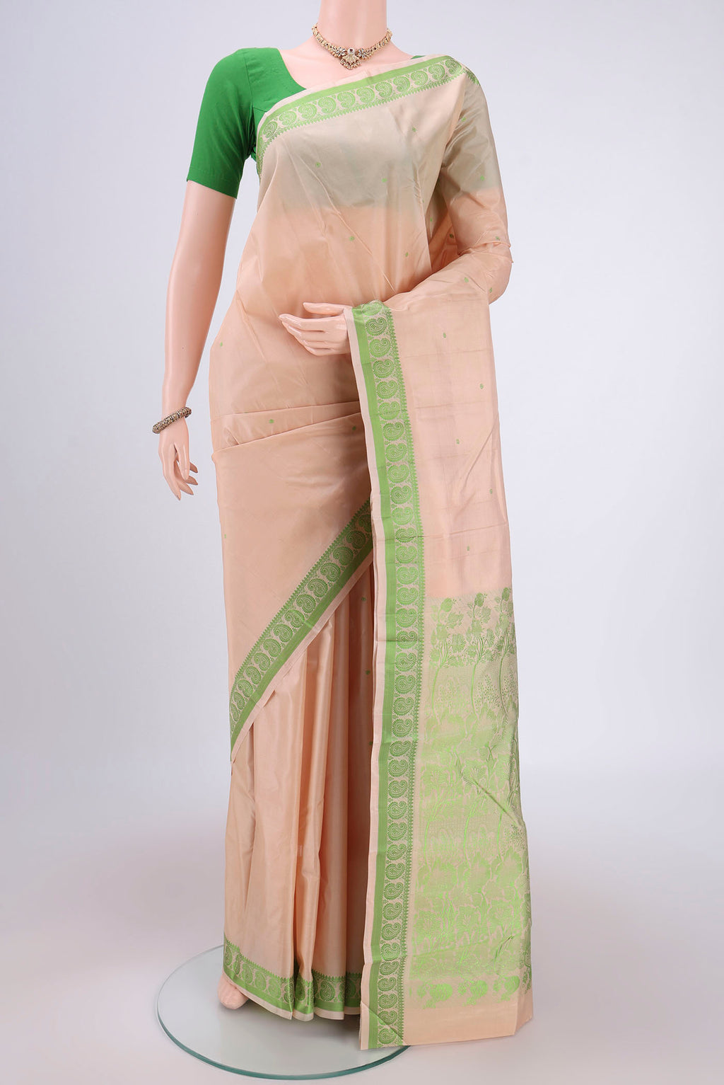 Cream Kanchipuram Silk Saree with Thread Butta on the body and Thread Border.  displayed on a mannequin