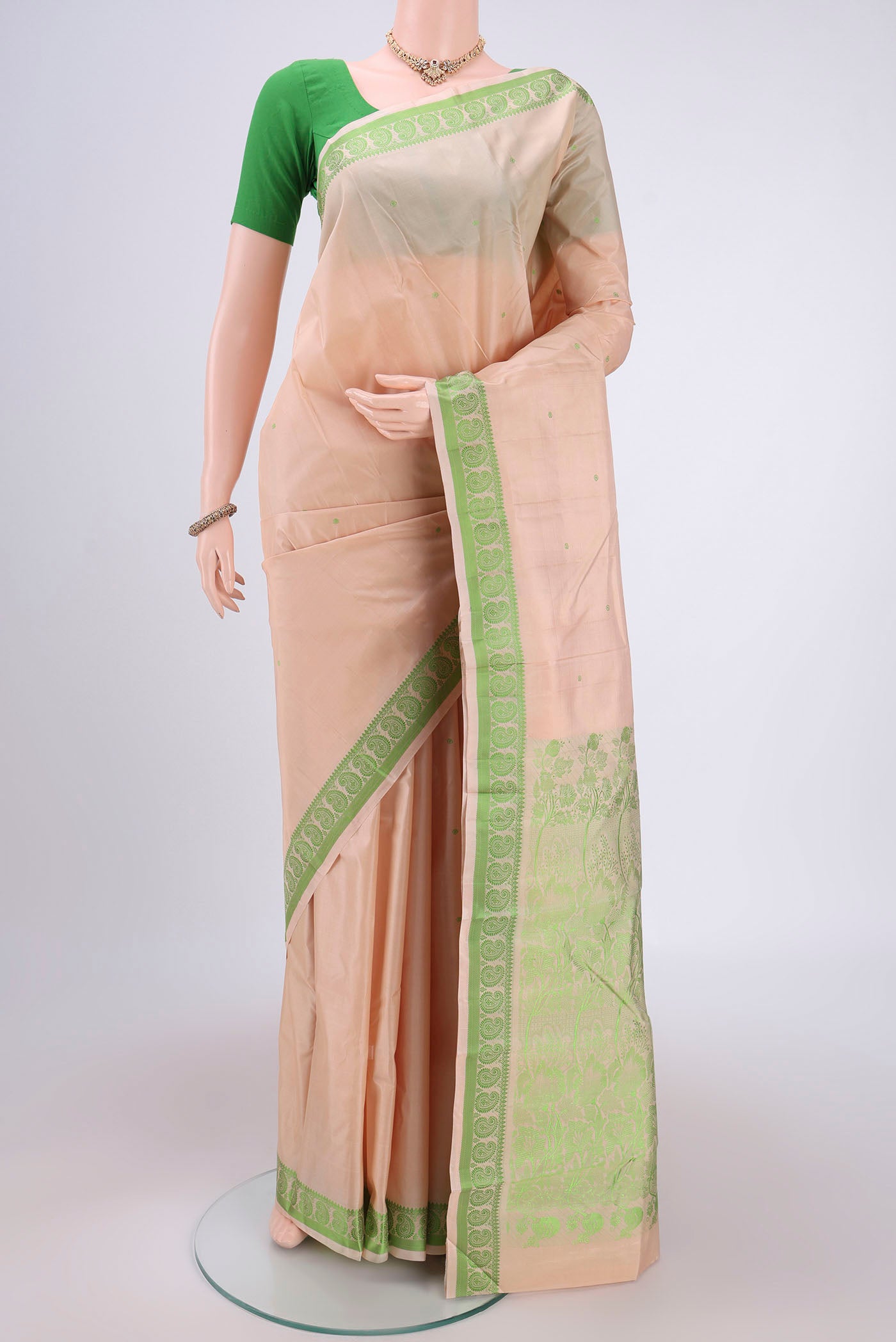 Cream Kanchipuram Silk Saree with Thread Butta on the body and Thread Border.  displayed on a mannequin