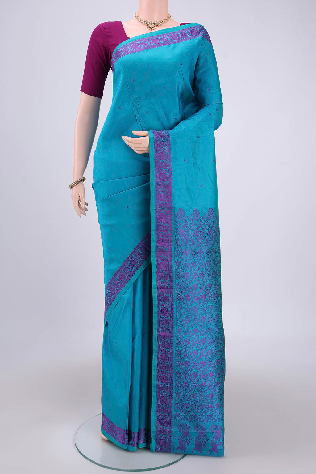 Blue Kanchipuram Silk Saree with Thread Butta on the body and Thread Border.  displayed on a mannequin
