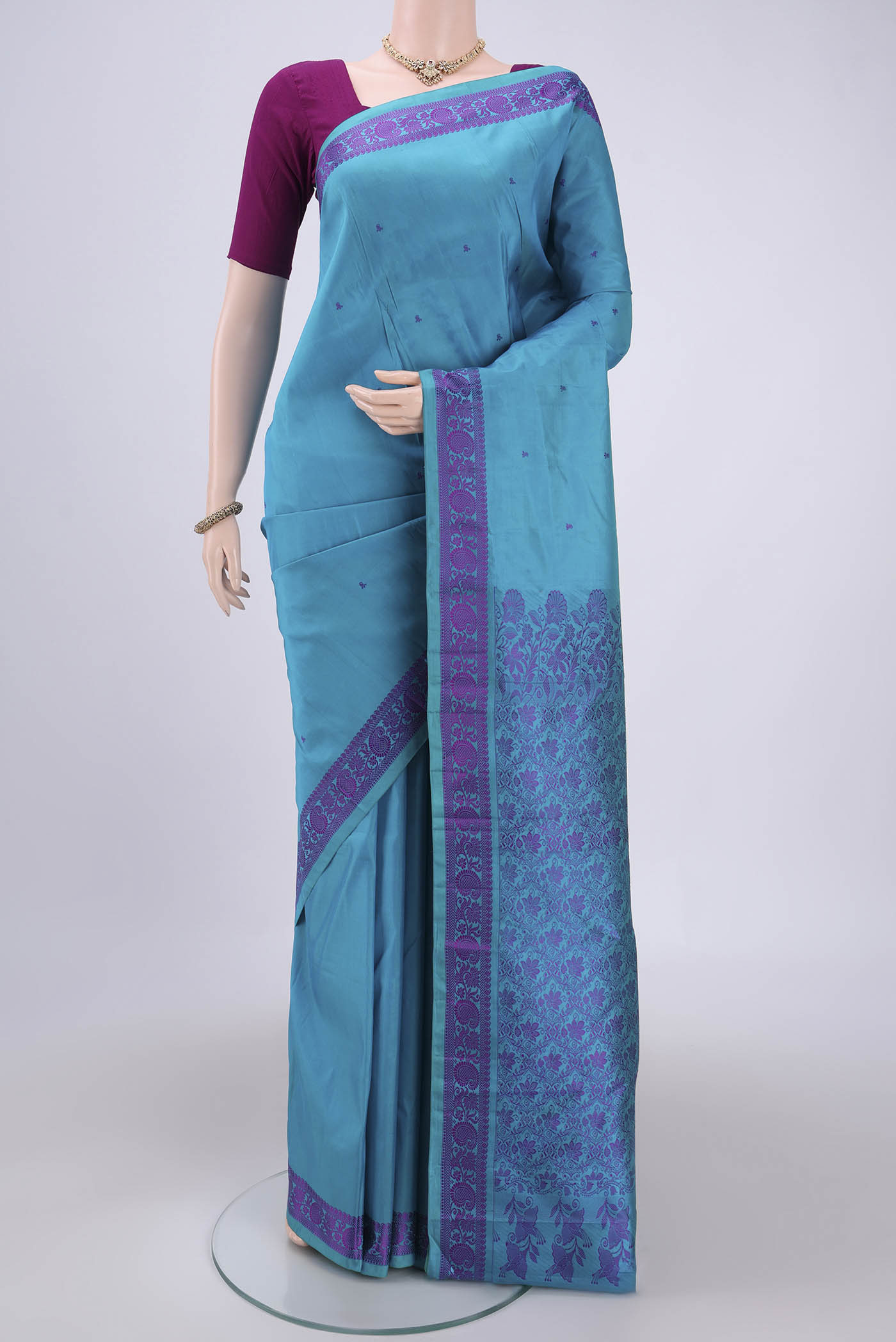 Blue Kanchipuram Silk Saree with Thread Butta on the body and Thread Border.  displayed on a mannequin