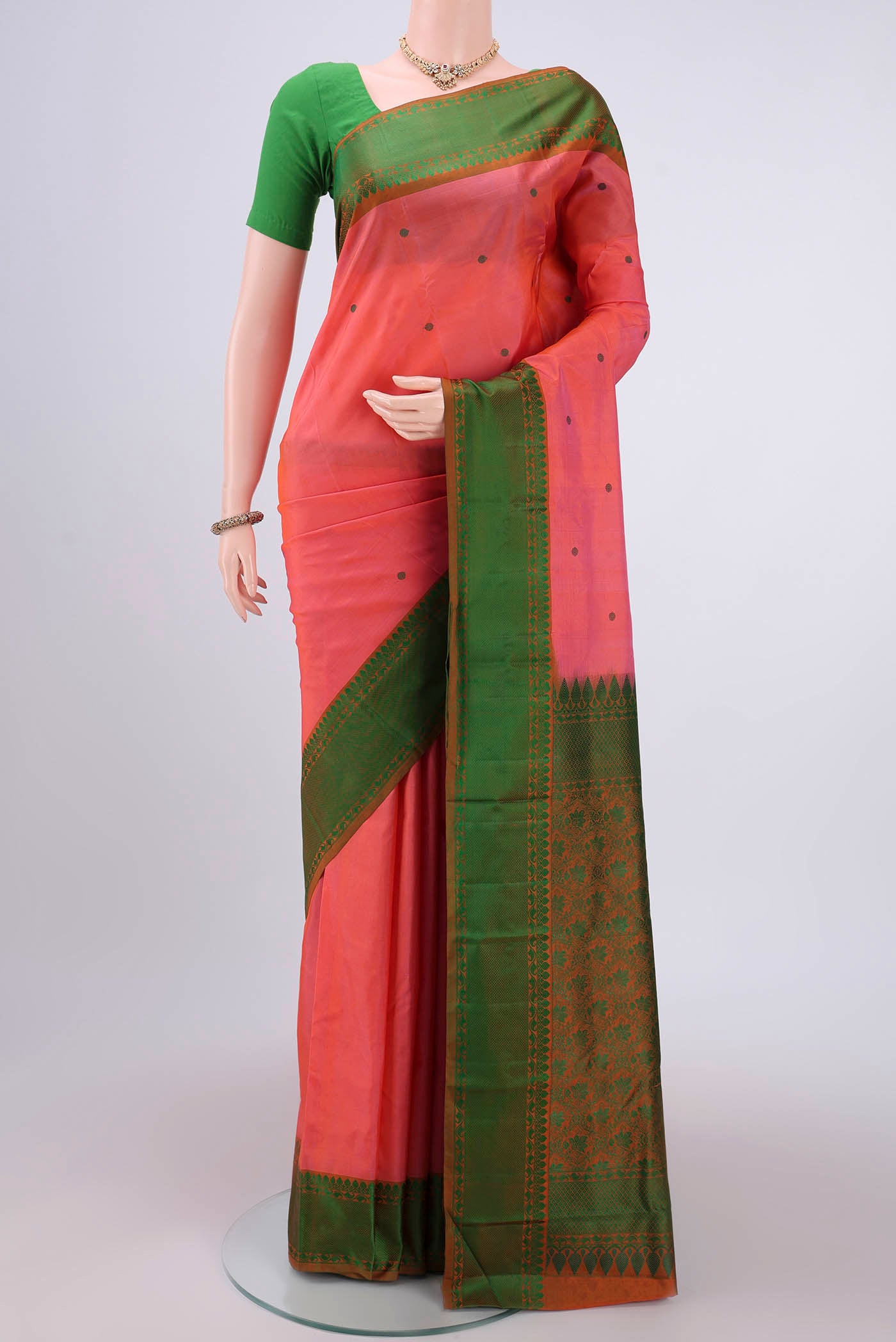 Peach Kanchipuram Silk Saree with Thread Butta on the body and Thread Border.  displayed on a mannequin
