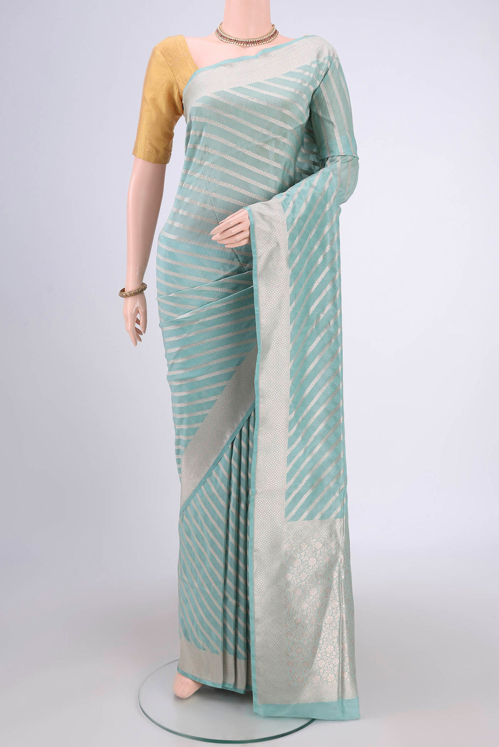 Sea Green Dual Tone Banarasi Silk Saree with Stripes on the body and Zari Border.  displayed on a mannequin