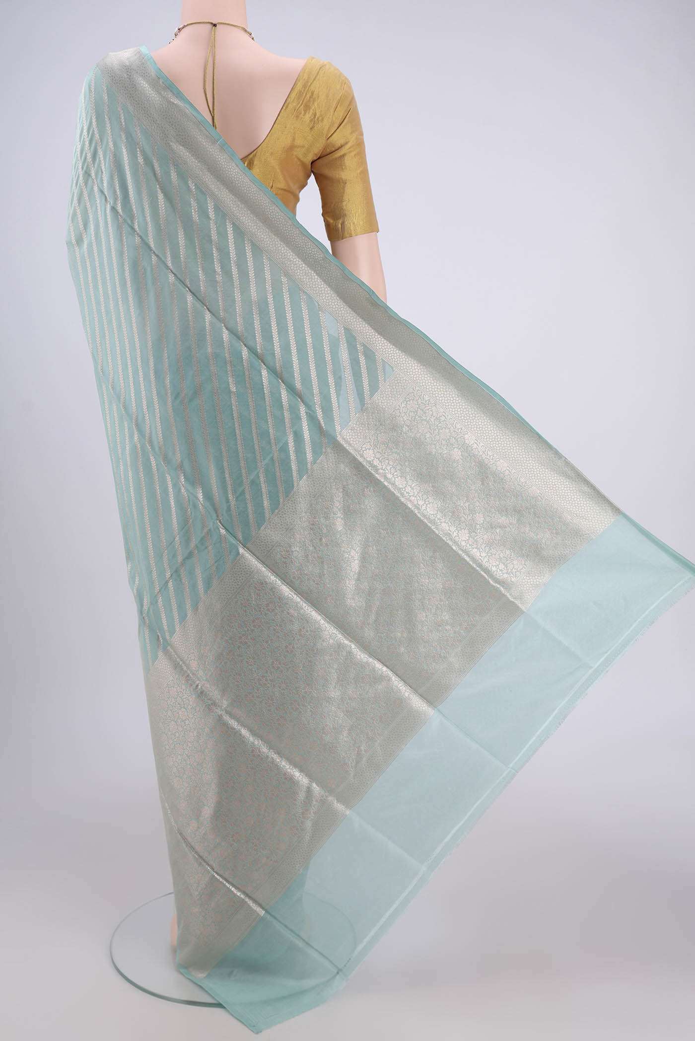 Flat view of Sea Green Dual Tone Banarasi Silk Saree with Stripes on the body and Zari Border. 