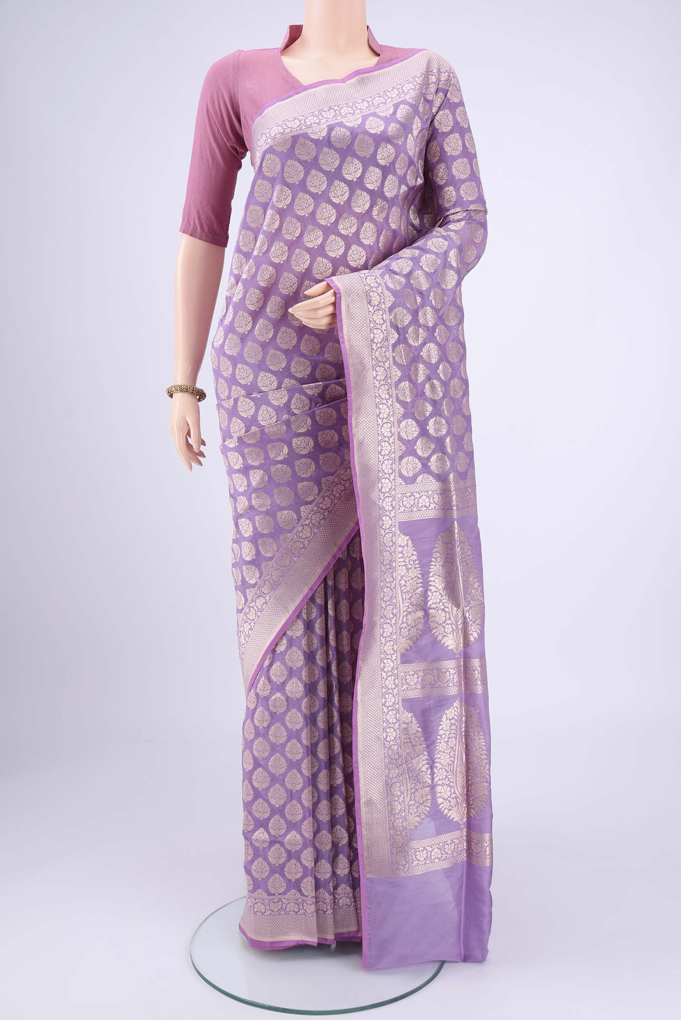 Lavender Banarasi Silk Saree with Zari Butta on the body and Zari Border.  displayed on a mannequin