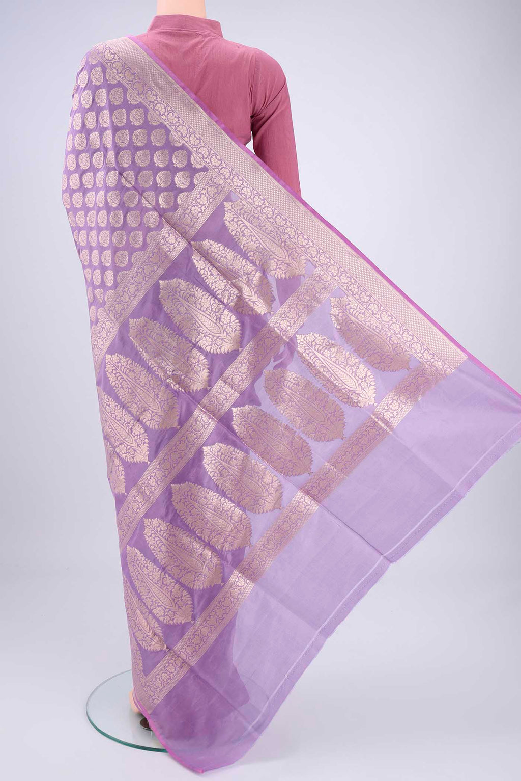 Flat view of Lavender Banarasi Silk Saree with Zari Butta on the body and Zari Border. 