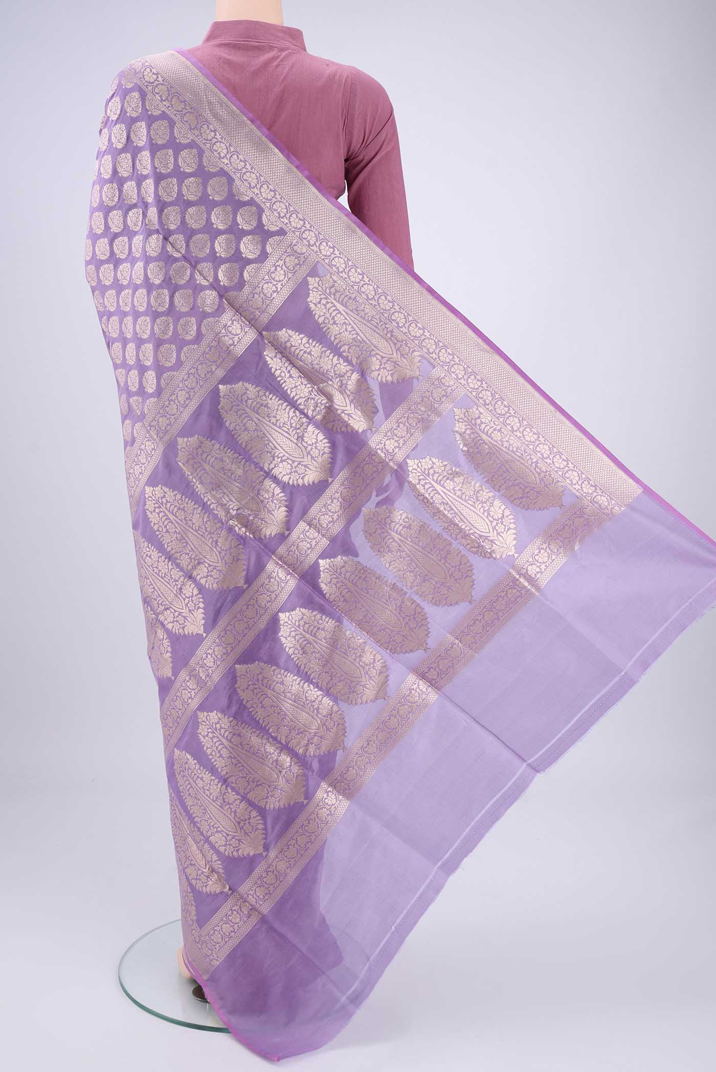 Flat view of Lavender Banarasi Silk Saree with Zari Butta on the body and Zari Border. 
