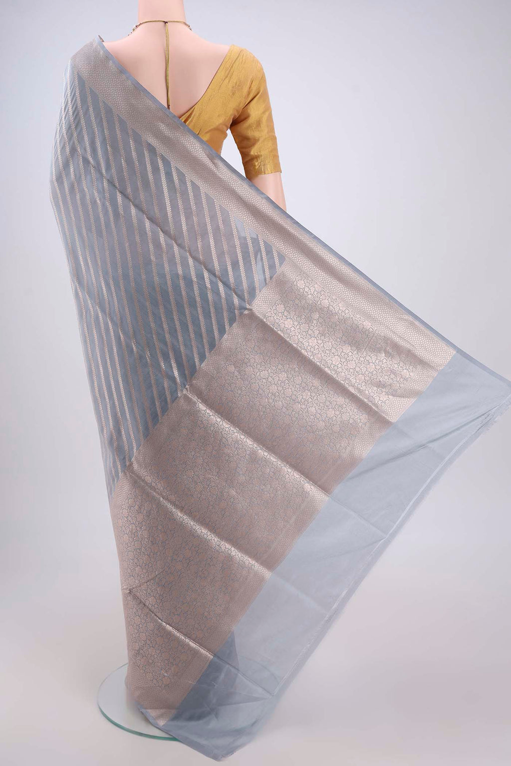 Flat view of Blue Grey Banarasi Silk Saree with Stripes on the body and Zari Border. 