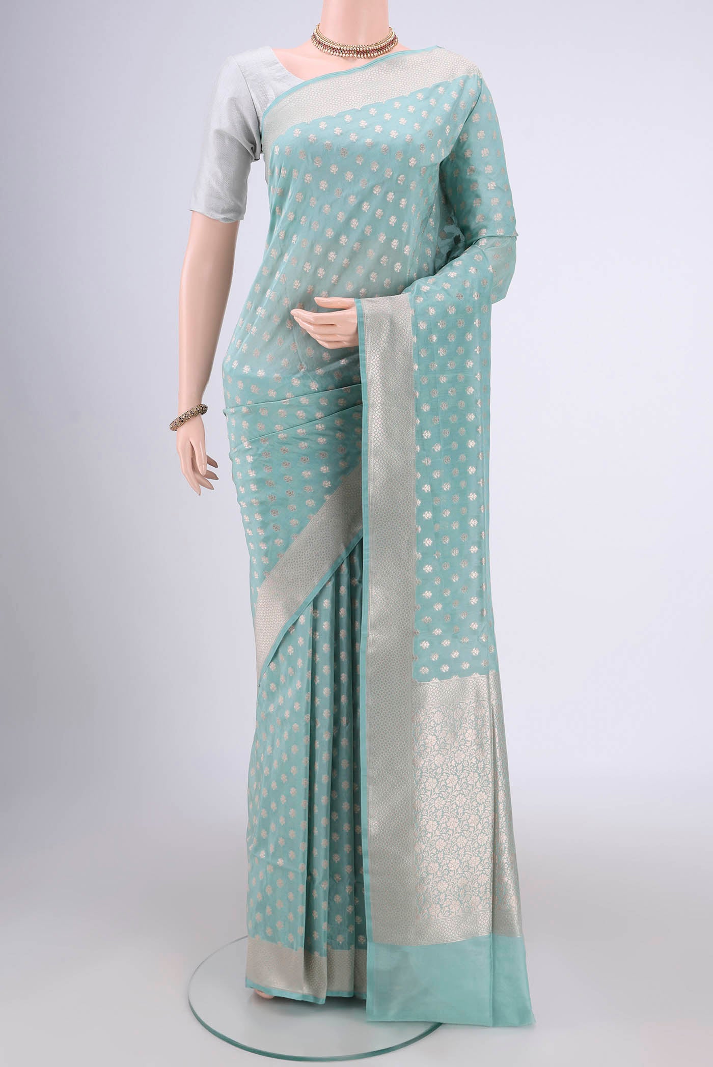 Sky Blue Banarasi Silk Saree with Zari Butta on the body and Zari Border.  displayed on a mannequin